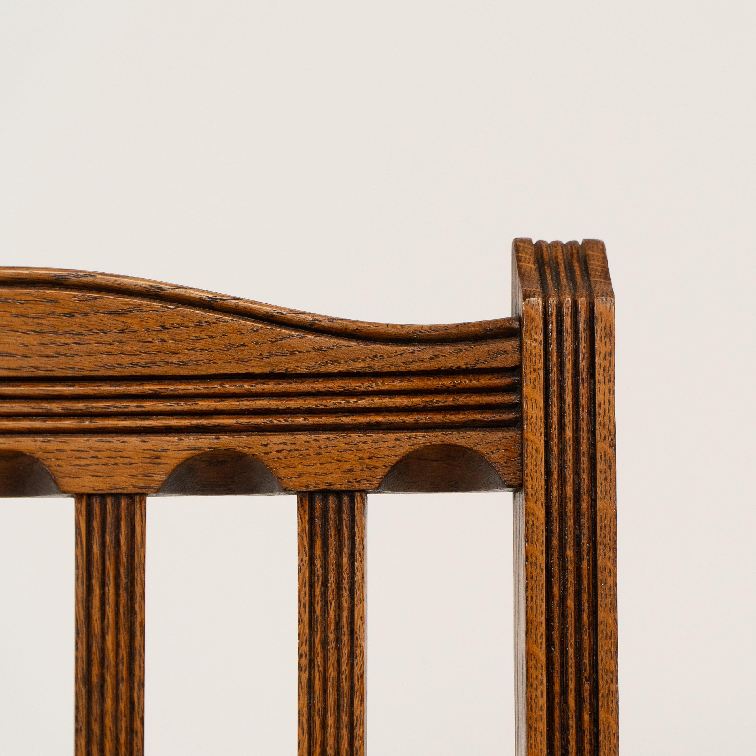 Jas Shoolbred. A set of four Aesthetic Movement lattice back oak dining chairs 1