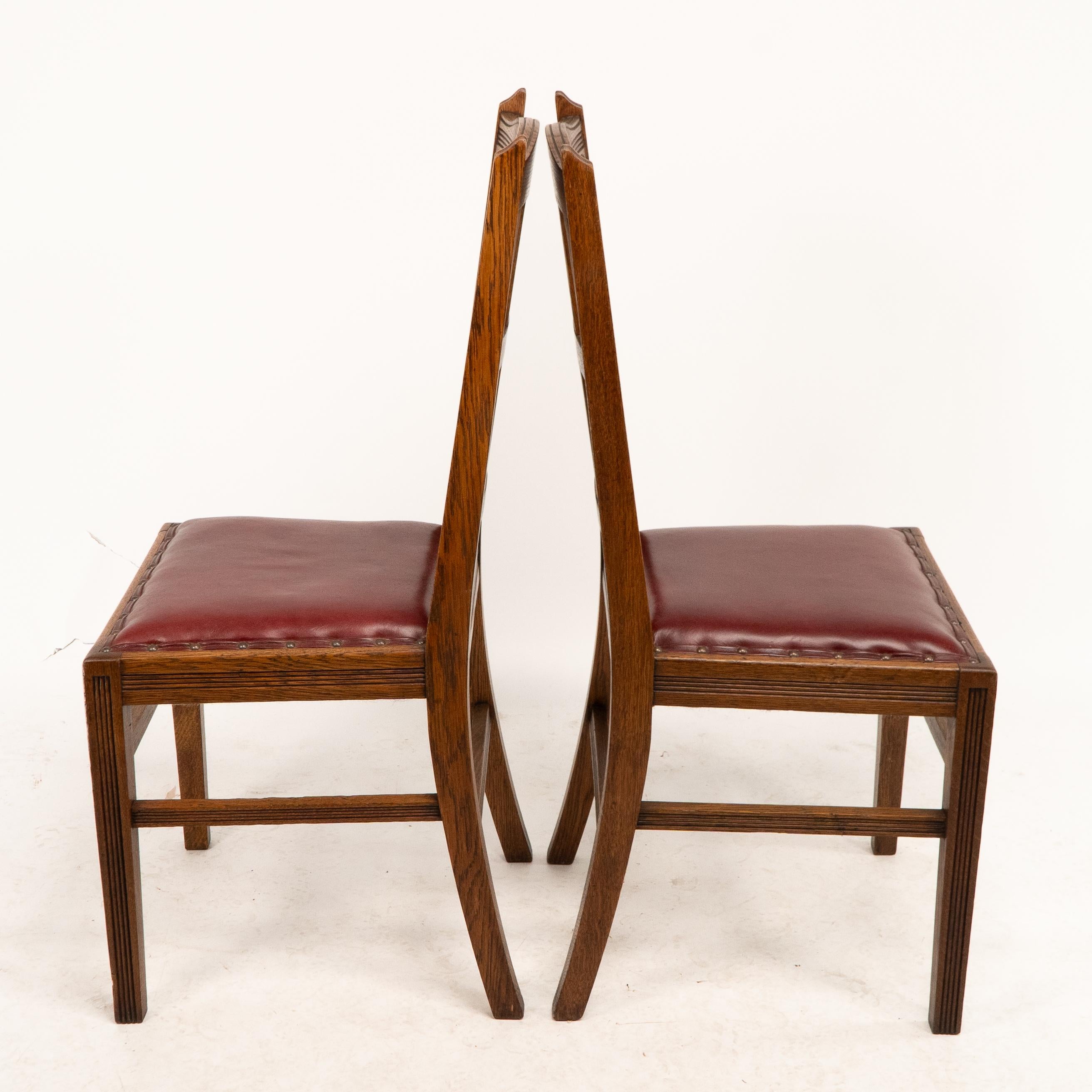 English Jas Shoolbred. A set of four Aesthetic Movement lattice back oak dining chairs