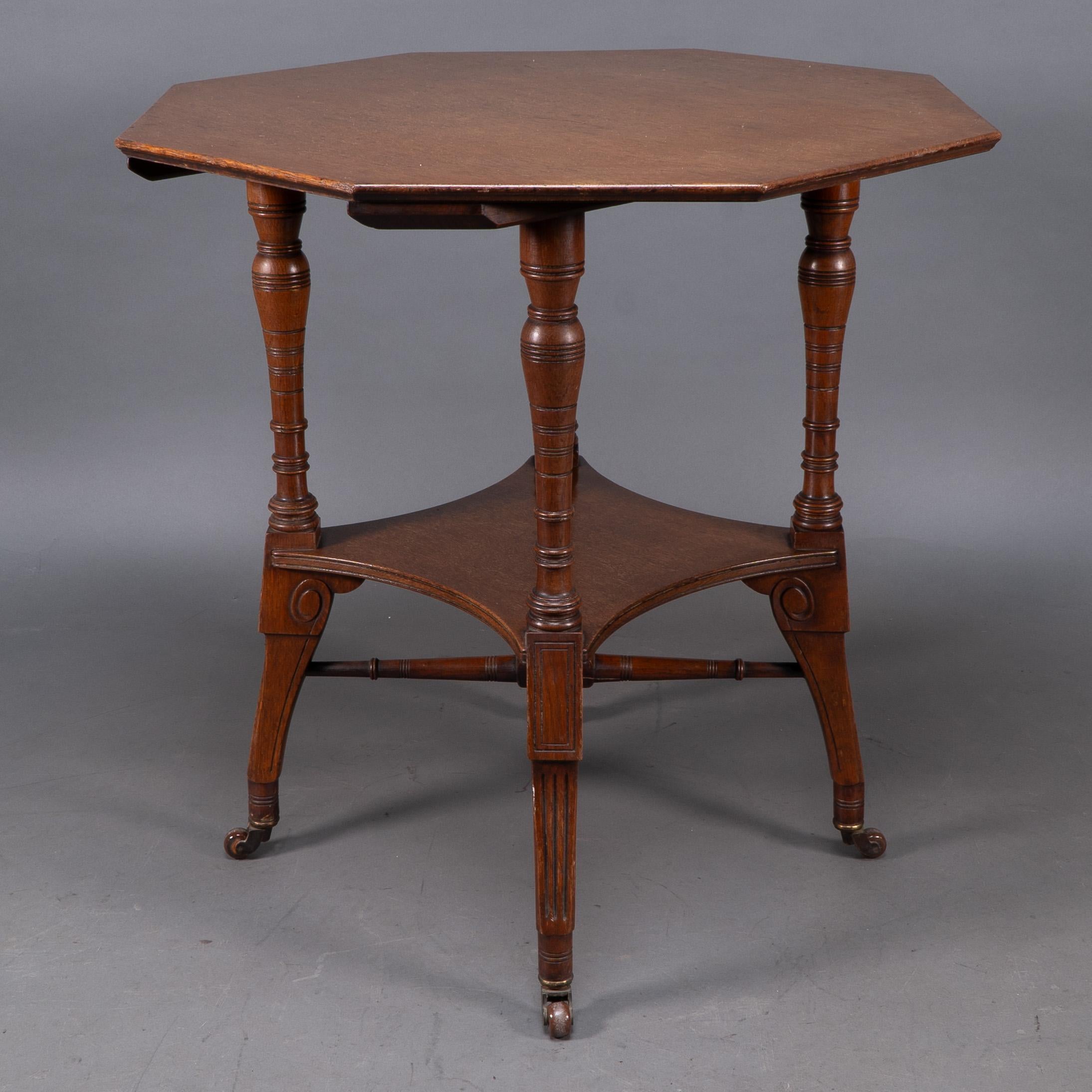 Jas Shoolbred. An Aesthetic Movement walnut octagonal center table For Sale 1