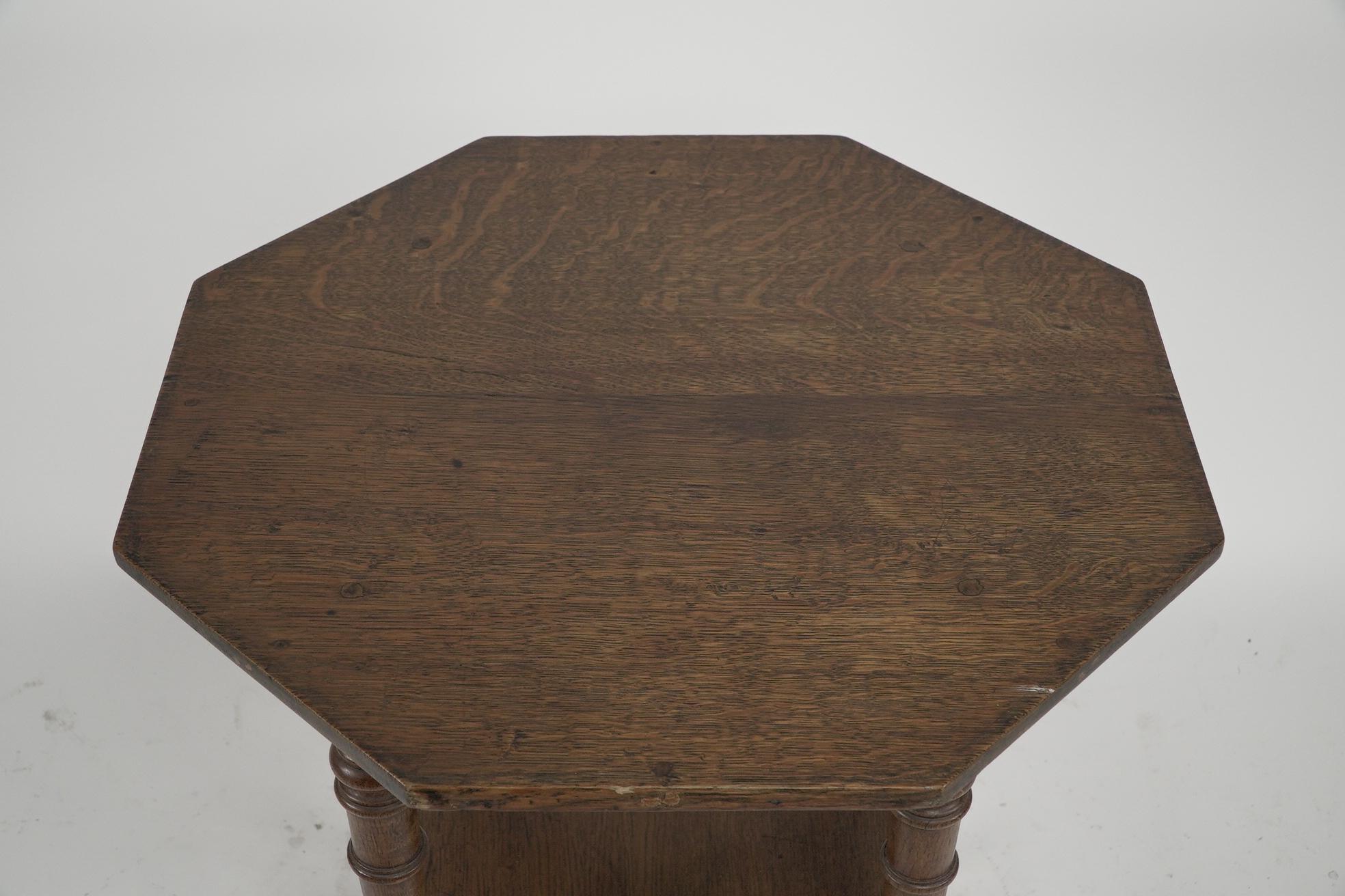 English Jas Shoolbred and Co (attributed) An octagonal oak side table with central shelf For Sale