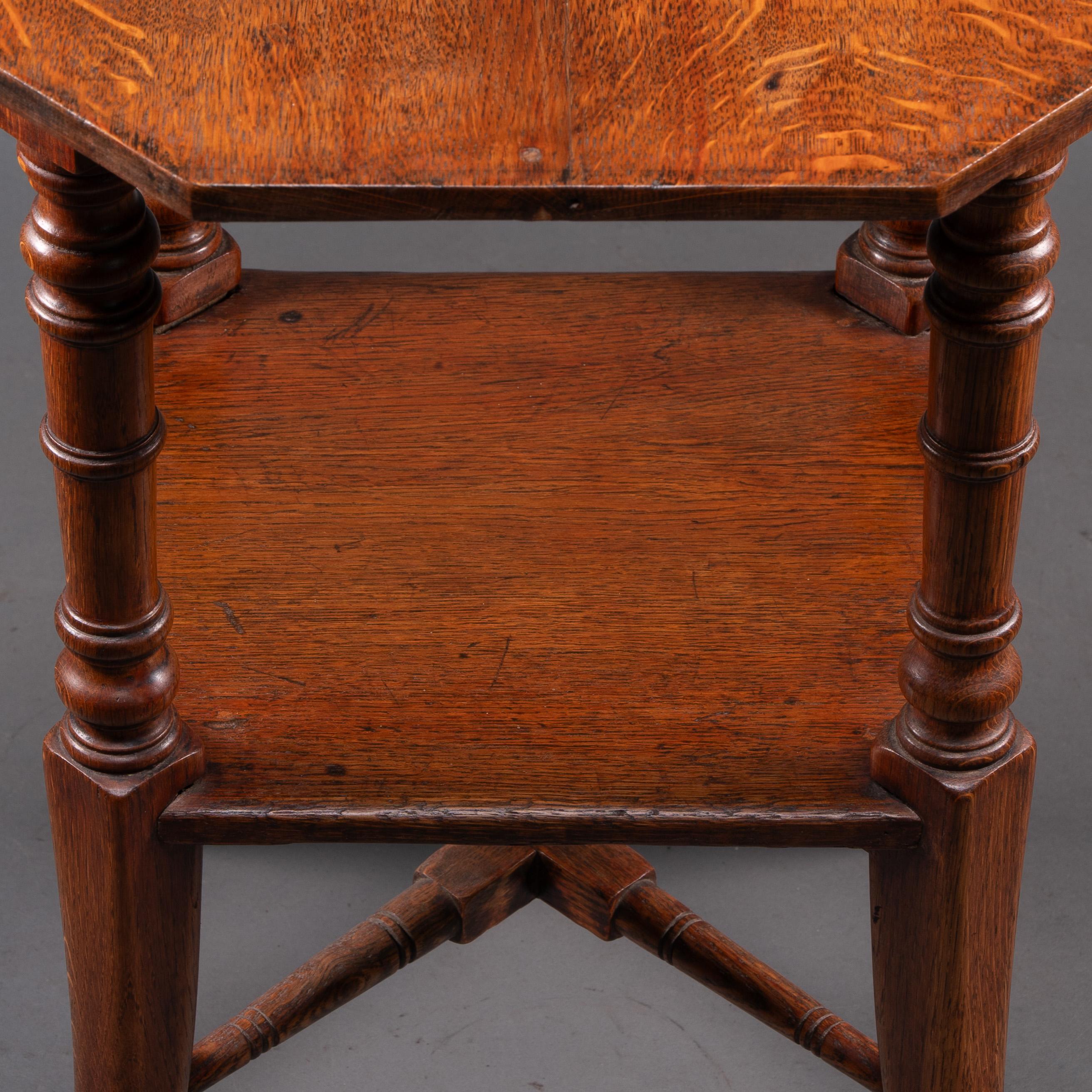 Jas Shoolbred and Co (attributed) An octagonal oak side table with central shelf For Sale 2