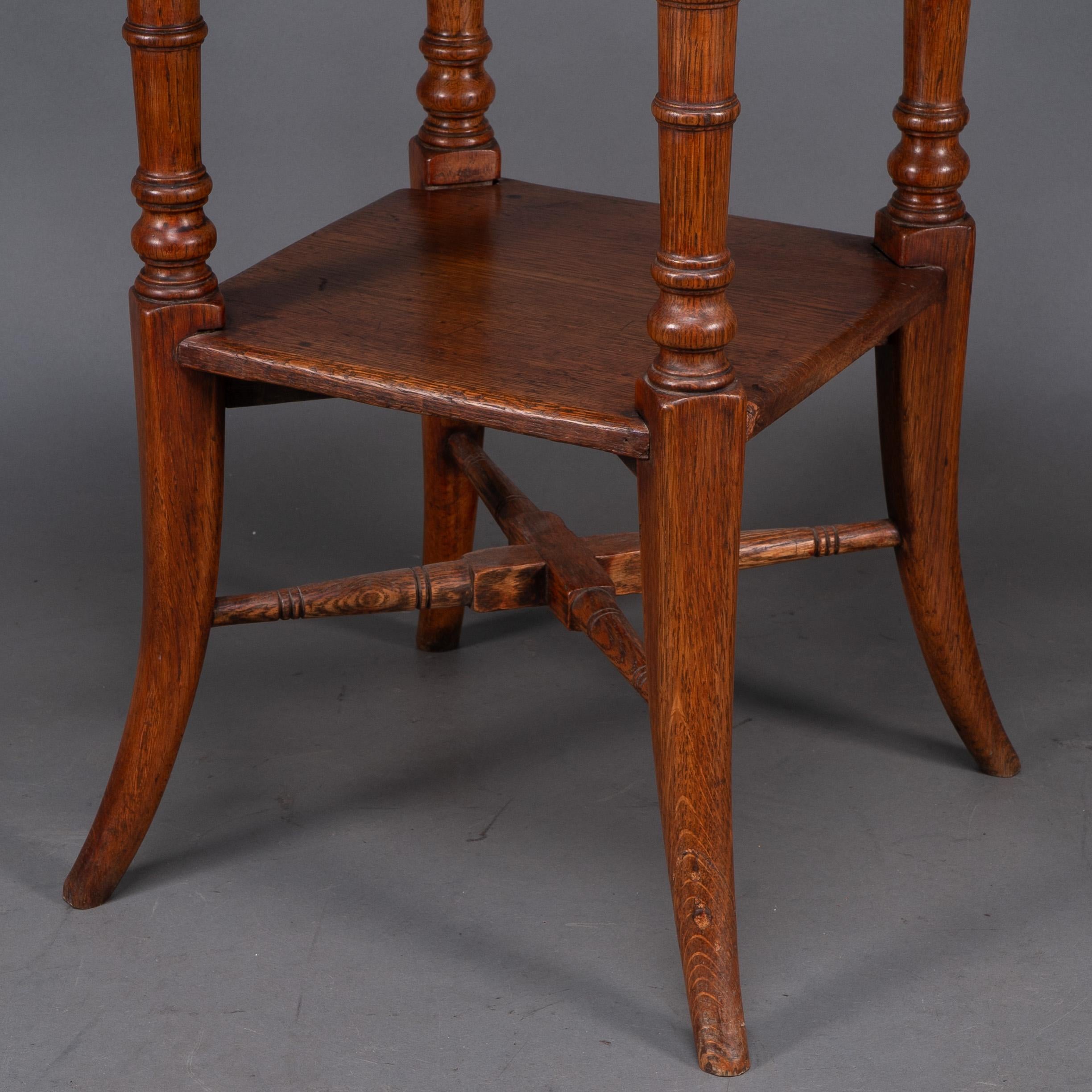 Jas Shoolbred and Co (attributed) An octagonal oak side table with central shelf For Sale 4