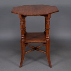 Jas Shoolbred and Co (attributed) An octagonal oak side table with central shelf