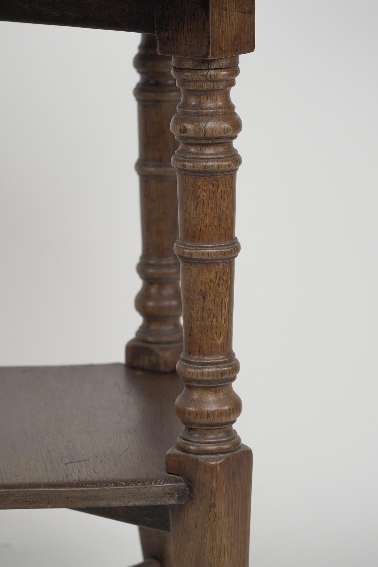 Jas Shoolbred and Co (attributed) An octagonal oak side table with central shelf For Sale 2