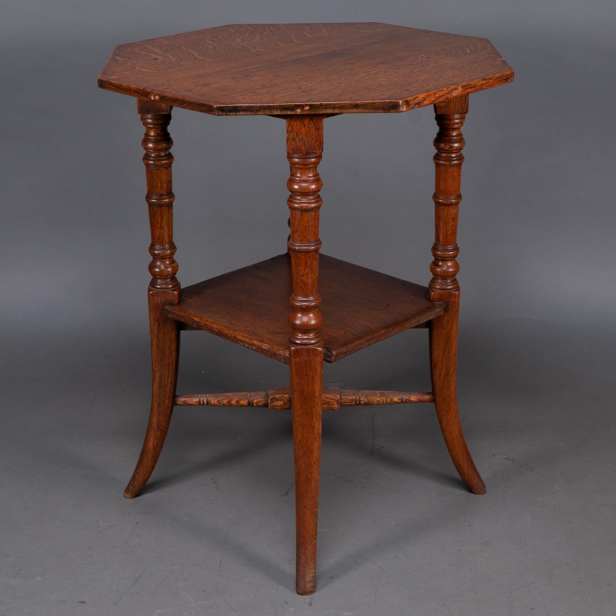 English Jas Shoolbred and Co (attributed) An octagonal oak side table with central shelf For Sale