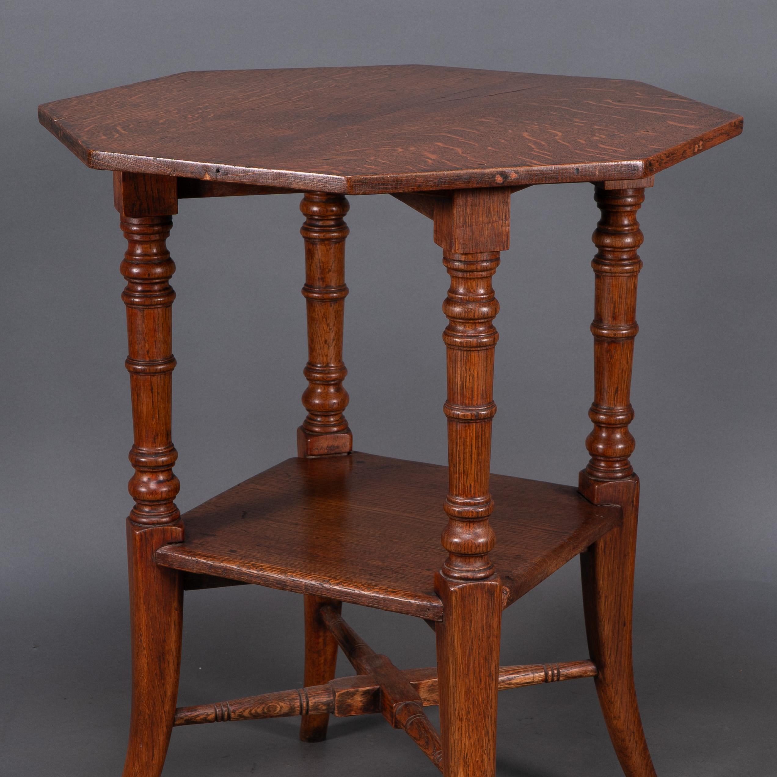 Oak Jas Shoolbred and Co (attributed) An octagonal oak side table with central shelf For Sale