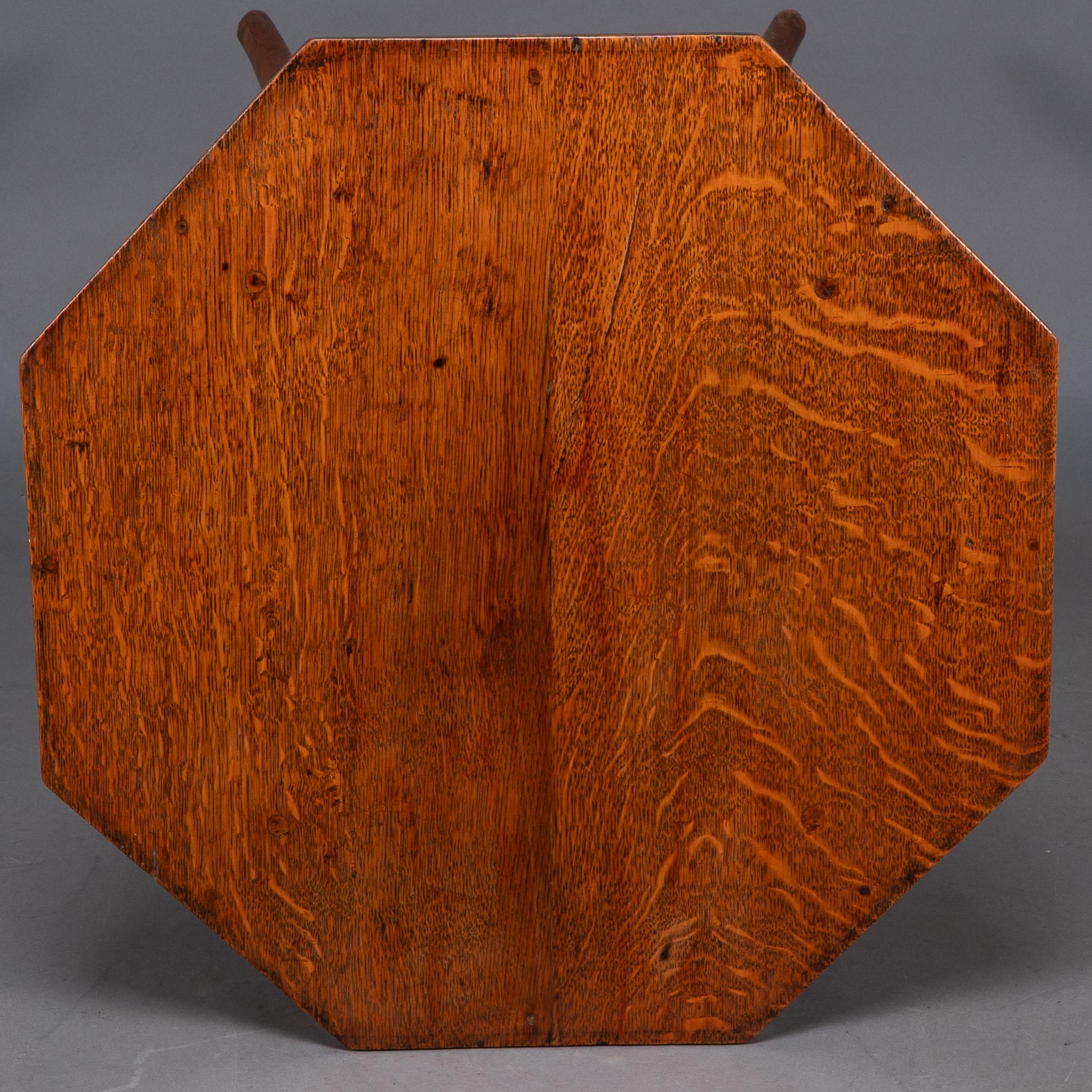 Jas Shoolbred and Co (attributed) An octagonal oak side table with central shelf For Sale 1