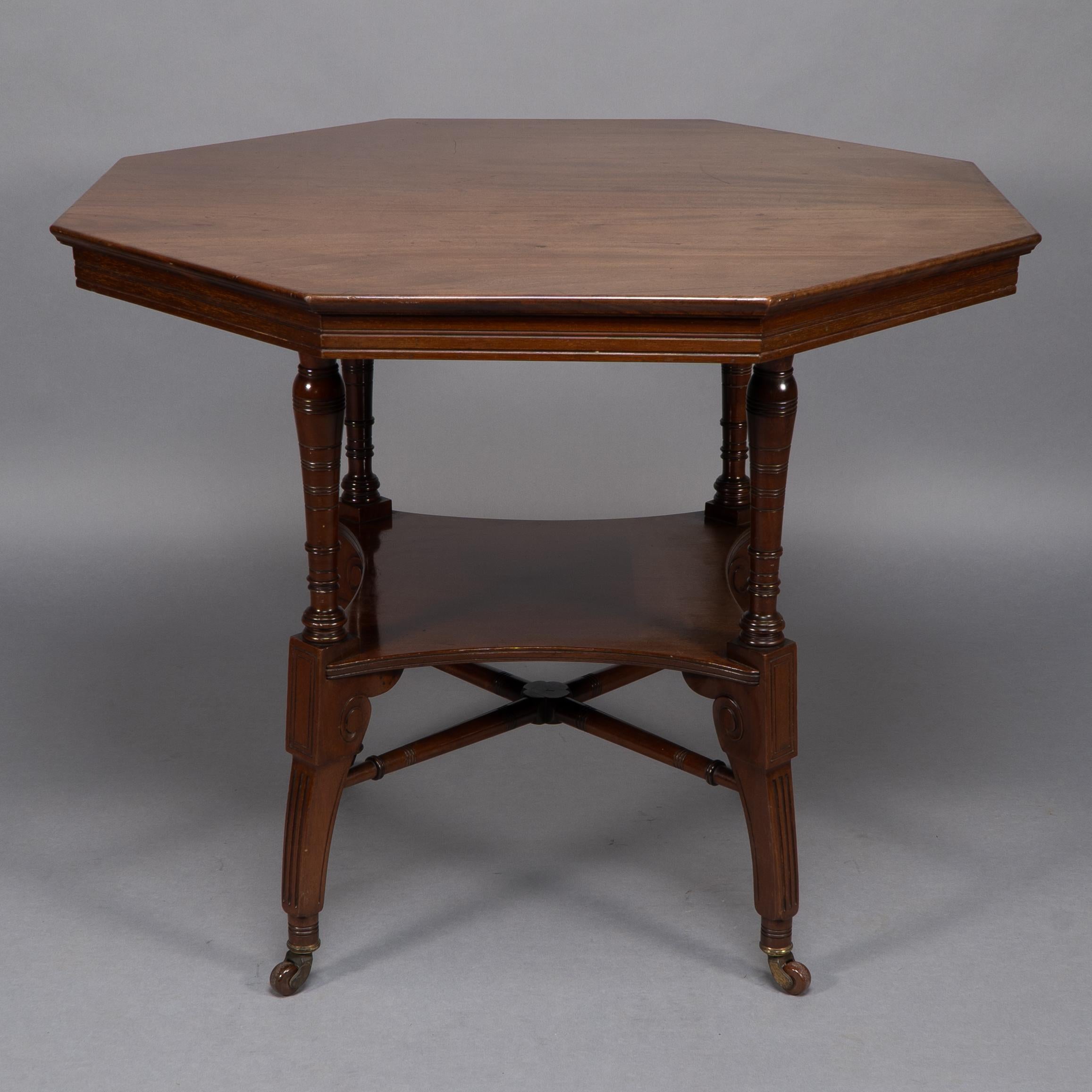 Jas Shoolbred Attri, An Aesthetic Movement Octagonal Shaped Centre Table with lower shelf and turned cross stretchers below.