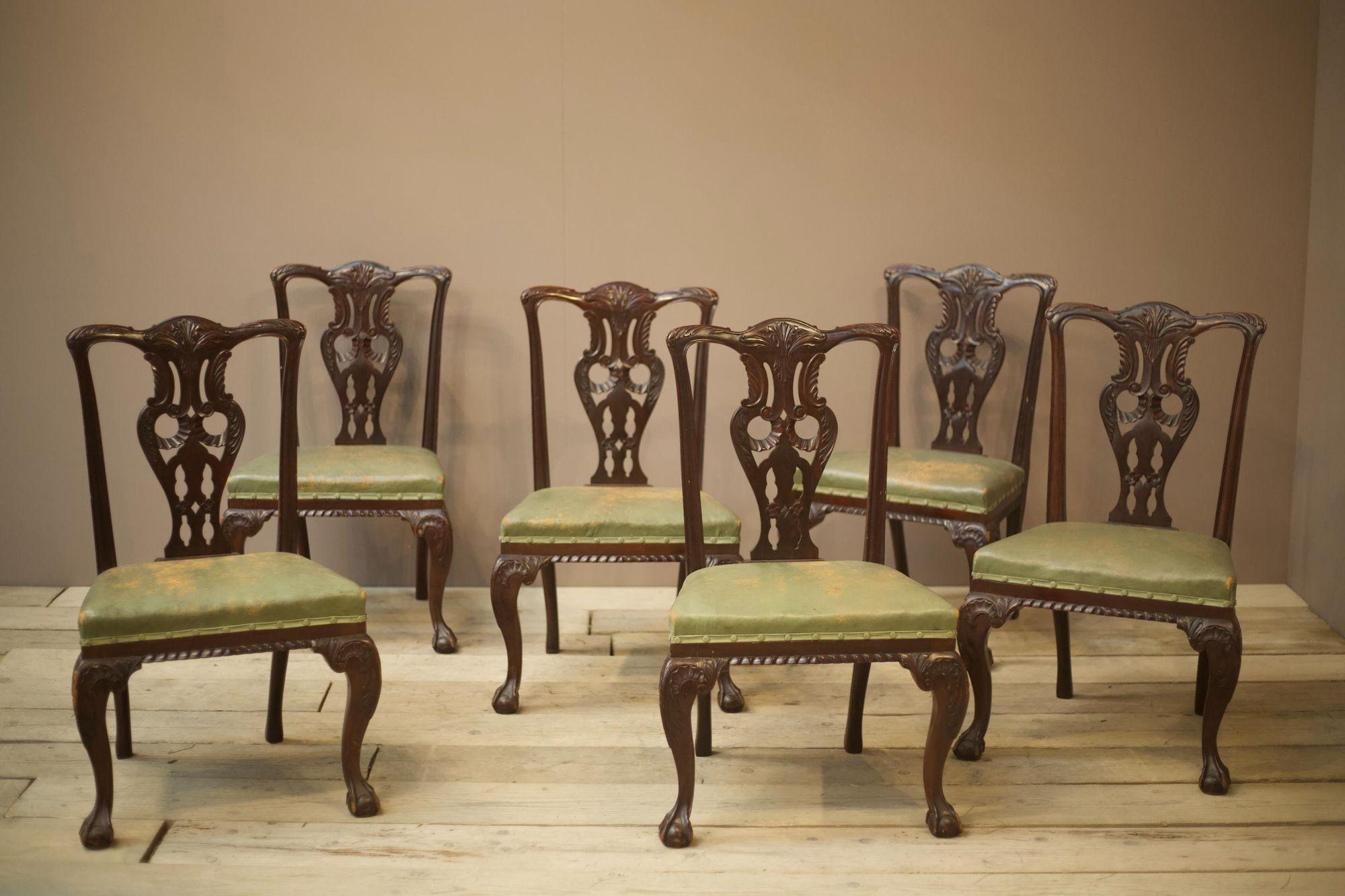 These are a fabulous set of Jas Shoolbred dining chairs. Made of mahogany and very much in the Georgian style. The carved detail is very nicely done and gives these an extremely impressive design which is accentuated beautifully with the original