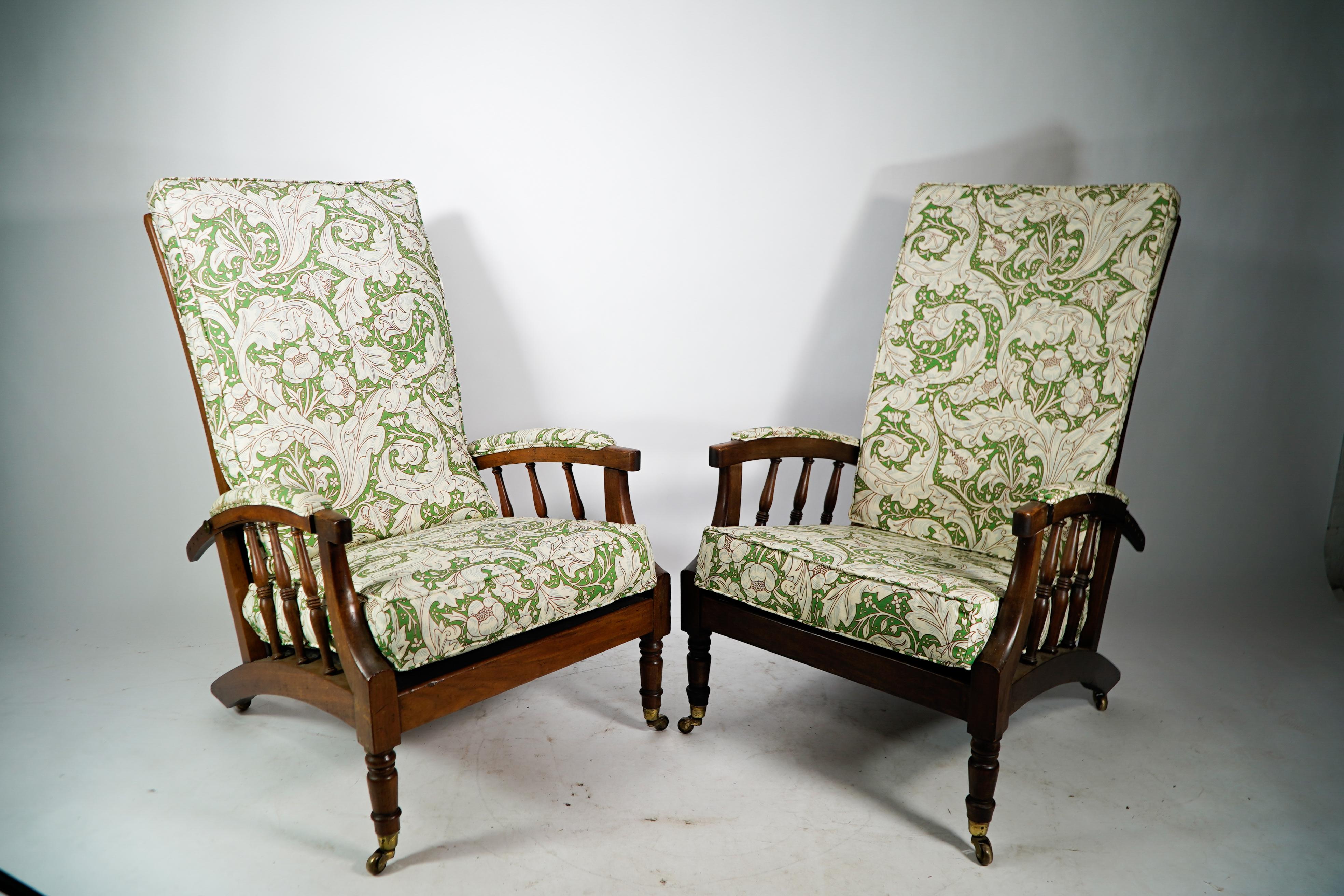 Jas Shoolbred.
In the style of Morris and Co, after a design by Phillip Webb.
A pair of Aesthetic Movement adjustable reclining armchairs. 
Professionally reupholstered in a Morris and Co style floral fabric.

James Shoolbred & Co also known as