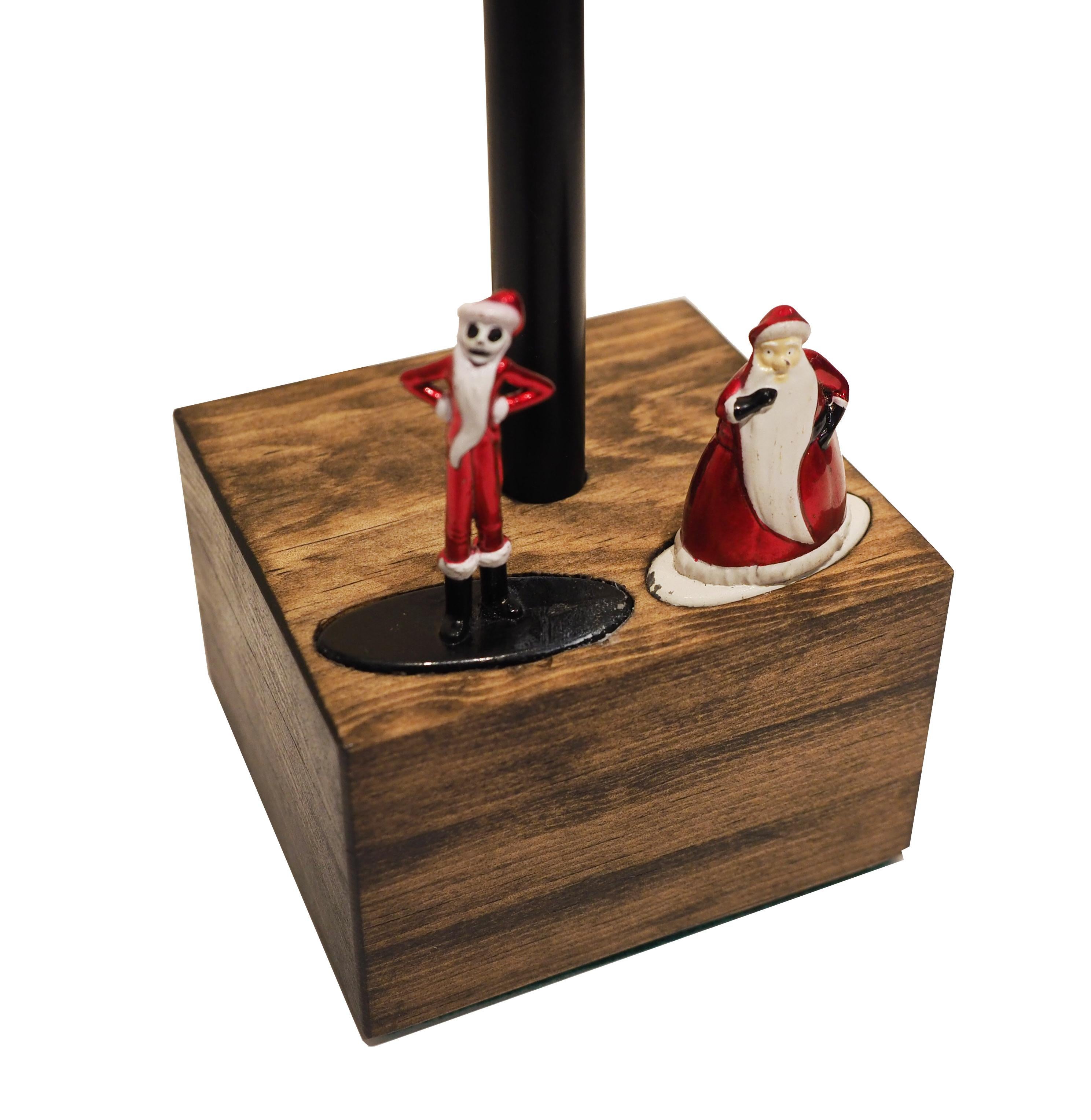 Limited set of touch lamps features a handcrafted hardwood base (walnut, poplar, and ash) inlaid with authentic vintage Nightmare Before Christmas die-cast metal figurines. Touch each figurine to adjust to three levels of brightness! 

(40-watt