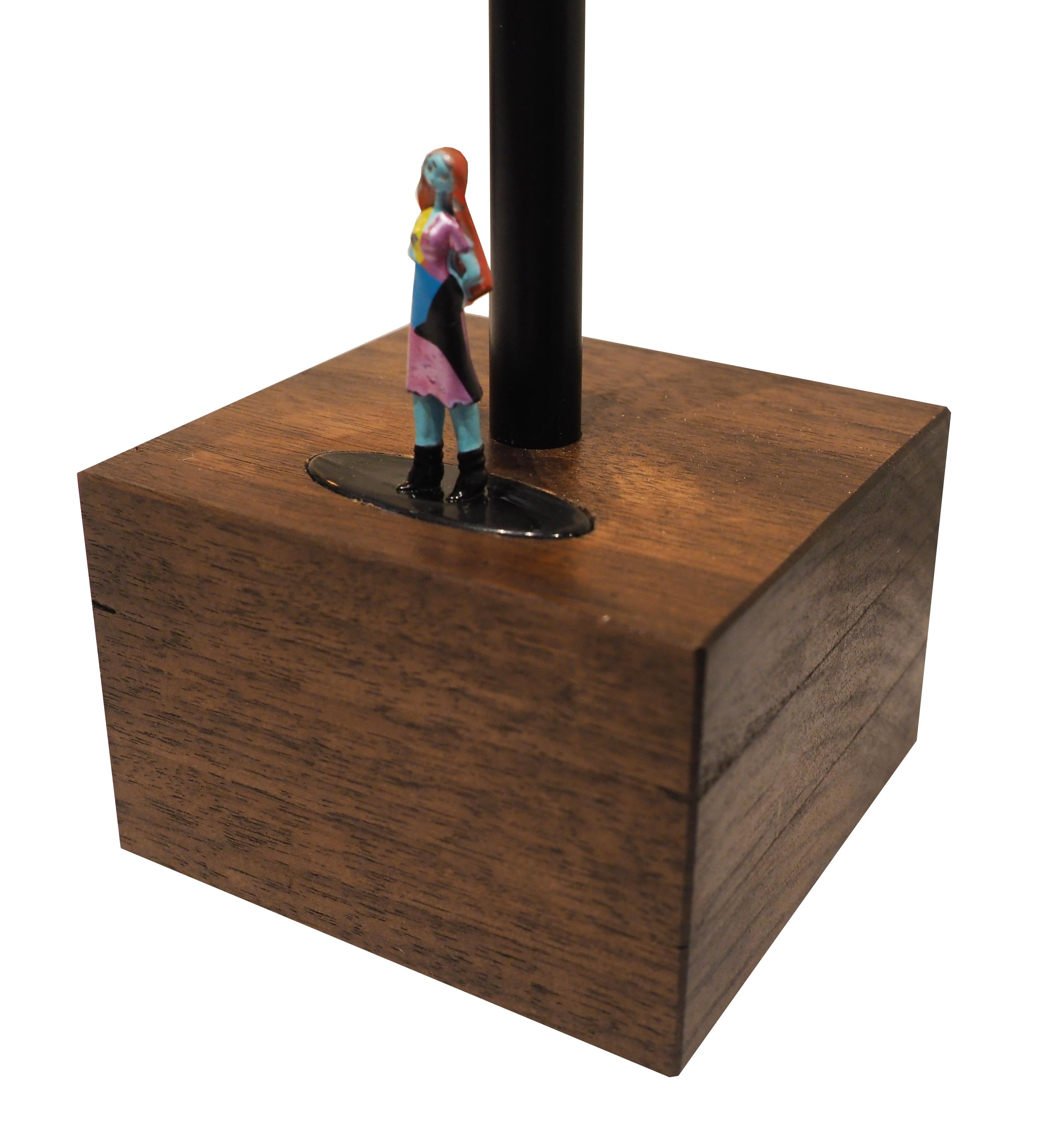 Limited set of touch lamps features a handcrafted hardwood base (walnut, poplar, and ash) inlaid with authentic vintage Nightmare Before Christmas die-cast metal figurines. Touch each figurine to adjust to three levels of brightness! 

(40-watt