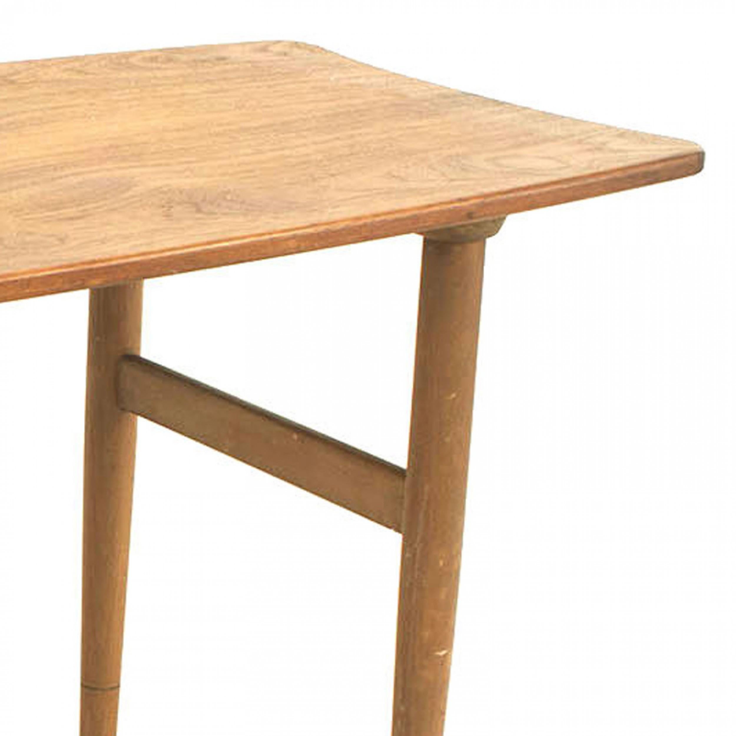 Danish Mid-Century Modern rectangular teak coffee table with shaped sides and tapered legs with each side connected with a stretcher. (attributed to JASON RINGSIDE)