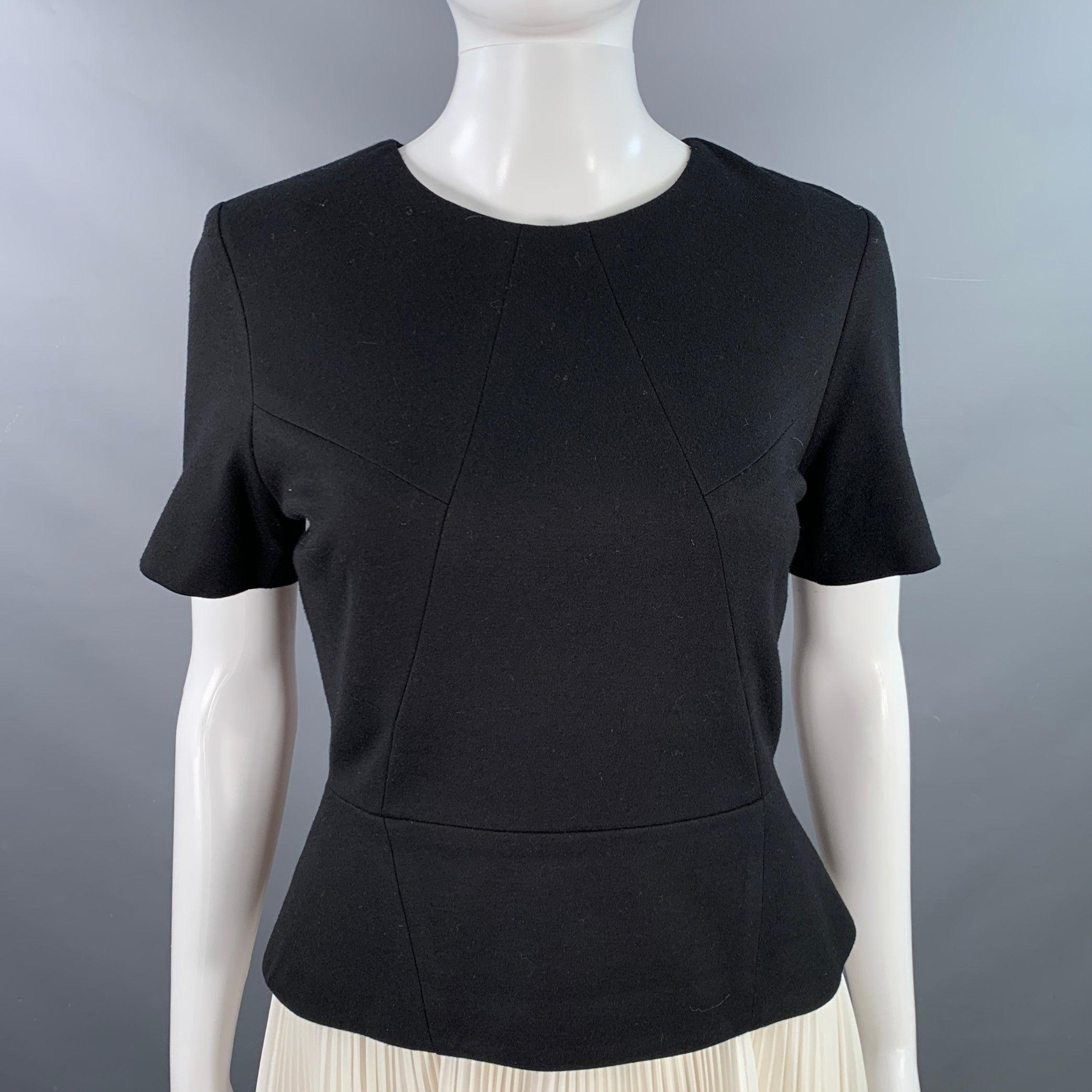 JASON WU cocktail dress
in a black rayon blend and white polyester featuring a two toned color block design, white pleated skirt, peplum waist, and back zipper closure.Very Good Pre-Owned Condition. Multiple minor marks in skirt. 

Marked:   6