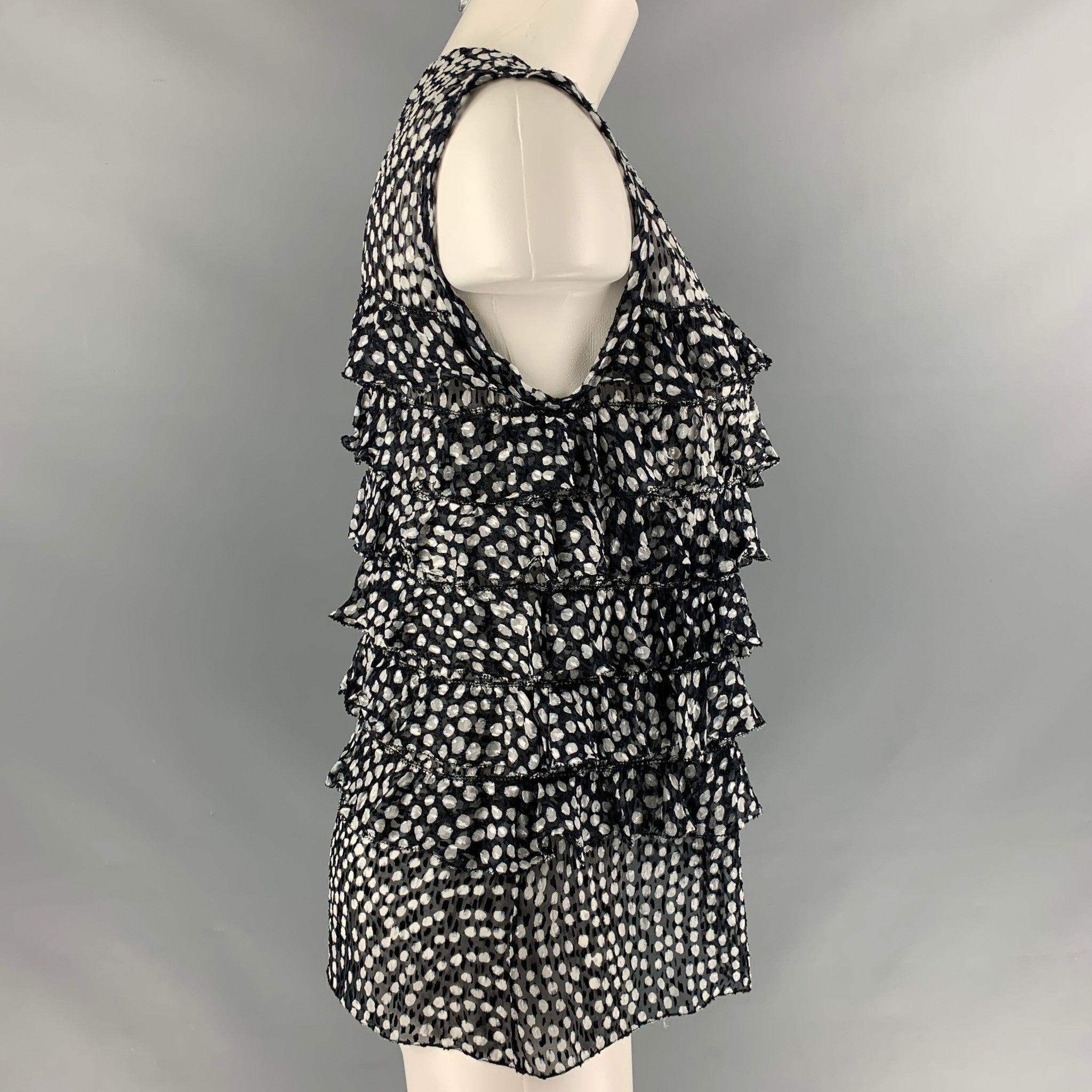 JASON WU sleeveless blouse comes in black and white dots print silk chiffon fabric featuring ruffles detail and button up closure. Made in USA.Excellent Pre-Owned Condition. 

Marked:   6 

Measurements: 
 
Shoulder: 13 inches Bust: 36 inches
