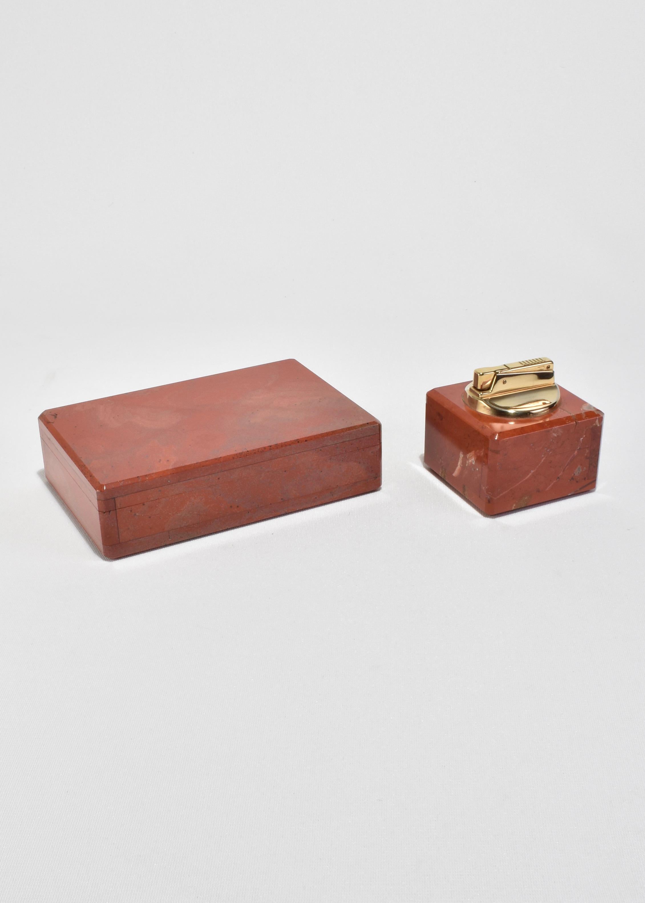 Italian box and table lighter set in richly veined red jasper with brass detail, made in the late 20th century. Both pieces are substantial in weight and presence—striking additions to a desk, bar, or coffee table. Lighter has been tested and is in