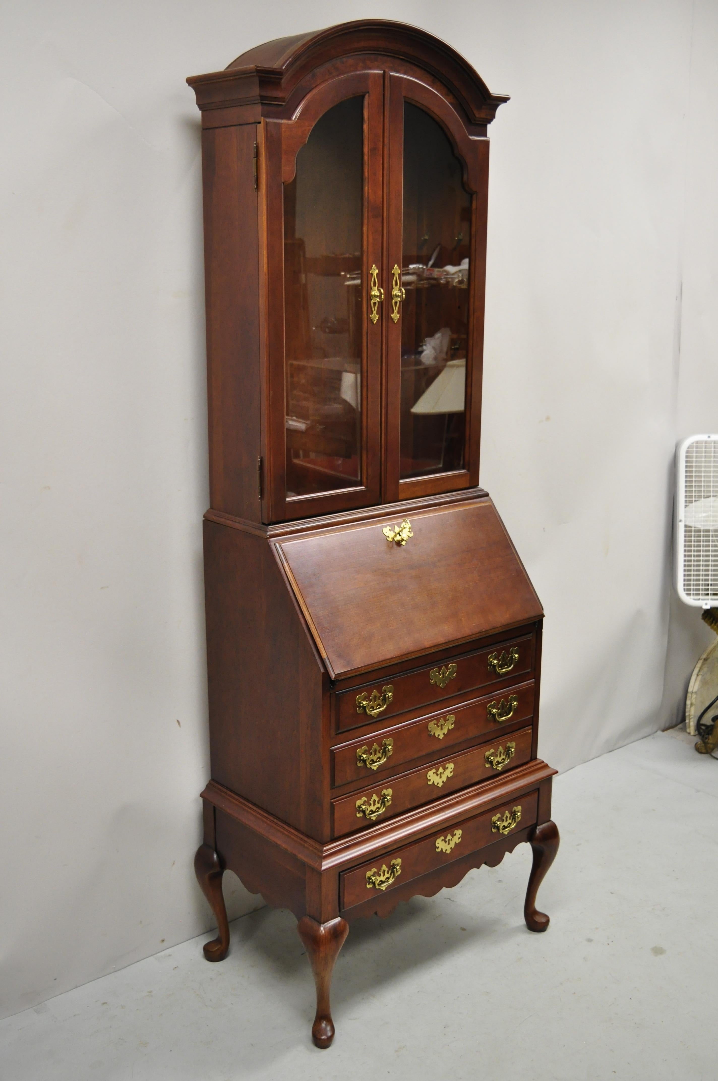 Jasper cabinet Co. cherry wood Queen Anne secretary desk display cabinet Curio. Item features bonnet top, solid wood construction, beautiful wood grain, 2 part construction, lighted interior, 2 swing doors, original label, working lock and key, 4