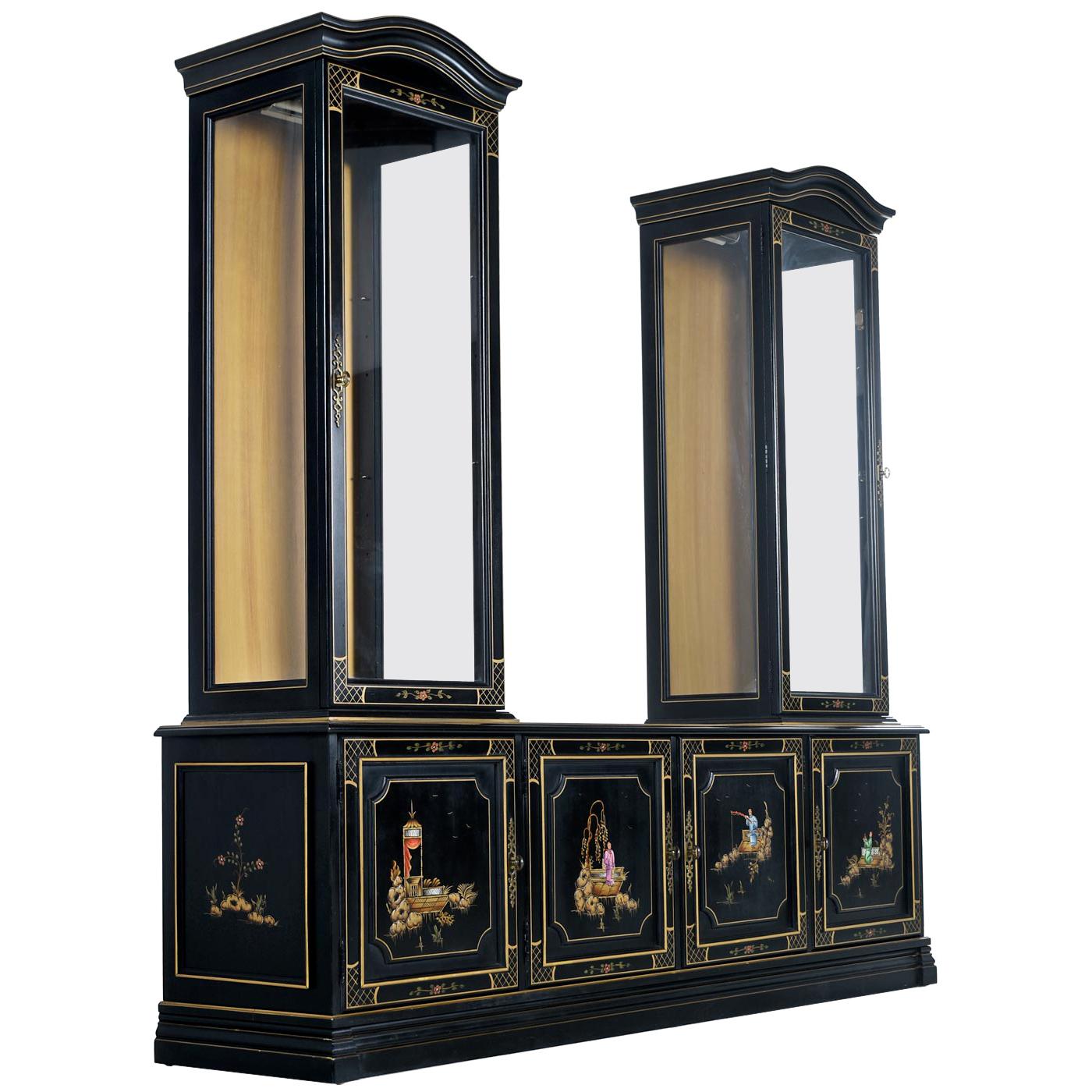 Expertly crafted with solid wood construction, this 1950s Jasper cabinet looks outstanding with it's gold gilt trim and hand painted Asian motif panels. Both glass display cabinet are lighted and individually wired. Arrange the modular / removable