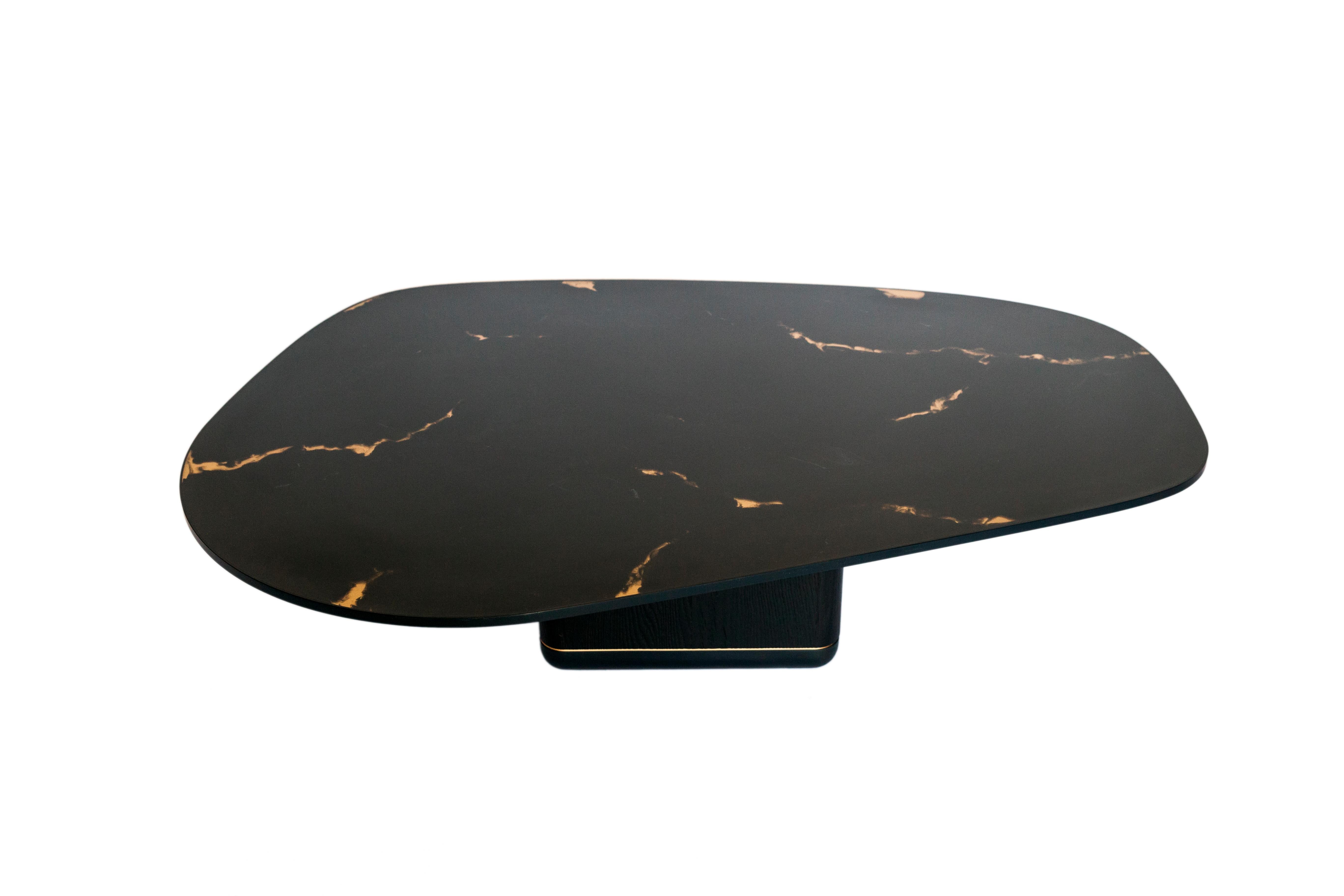 The sleek and striking curved jasper coffee table features a charred black oak base with blackened steel and bronze banding, and a black marbled rose bronze encased in resin tabletop with blackened steel banding.

Dimensions as shown: L 50 in. / W