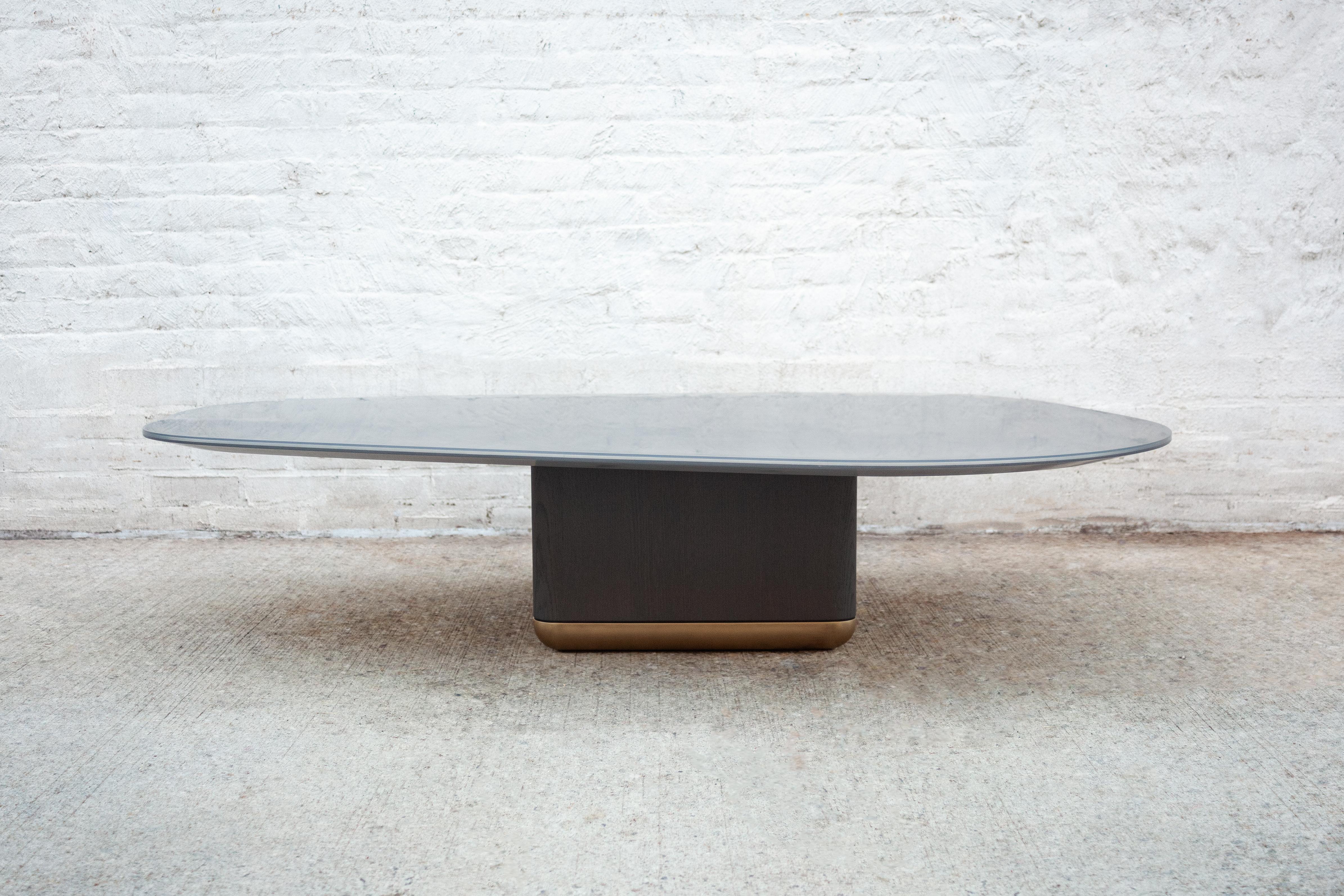 The sleek and striking curved jasper coffee table features a black oak and bronze base, and an irregular shaped tabletop featuring aluminum encased in resin. 

Dimensions as shown: L 60 in. / W 42 in. / H 14 in. 

Lead Time: 16-18 weeks 

Other