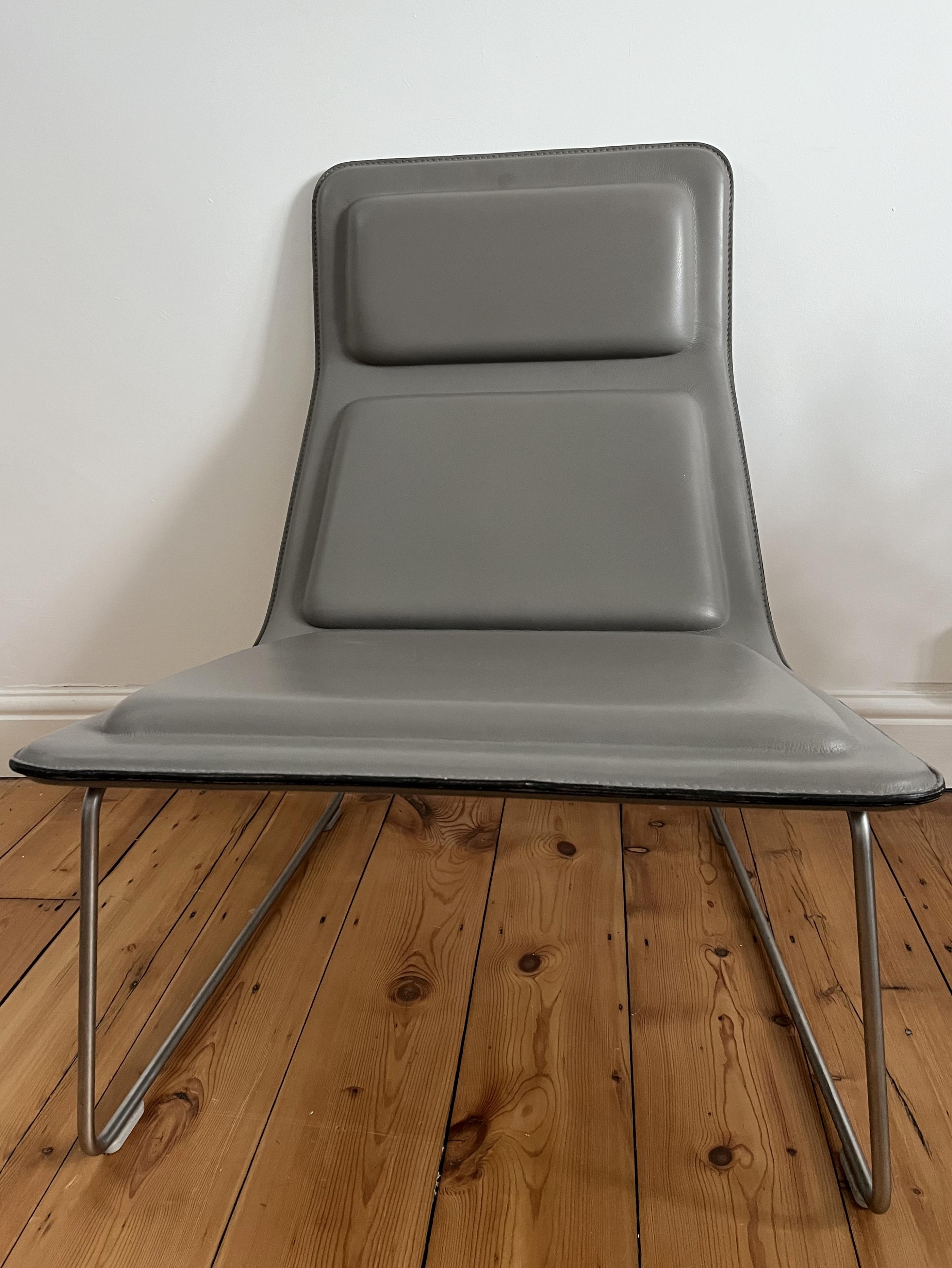 Low Pad Lounge Chair pour Cappellini, conçue par Jasper Morrison en 1999.

La chaise est recouverte de cuir gey et repose sur une base en acier inoxydable satiné.

Tous les patins sont présents et la chaise est en très bon état.

Nous en avons