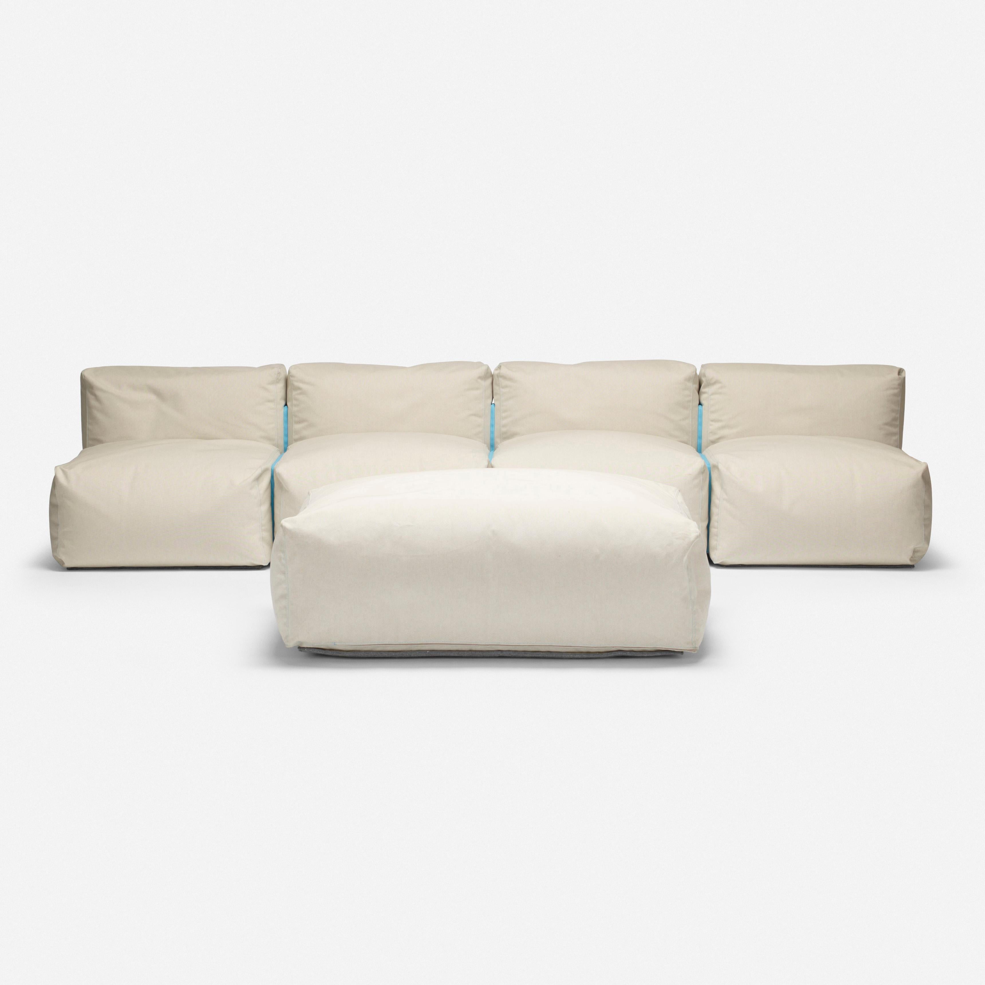 Made by: Cappellini, United Kingdom / Italy, 2004

Material: canvas upholstery

Size: 112 W × 36 D × 25 H in, seat height 13 inches

Description: Ottoman measures: 44 W x 39 D x 16 H inches. Sofa is composed of four seating elements with blue