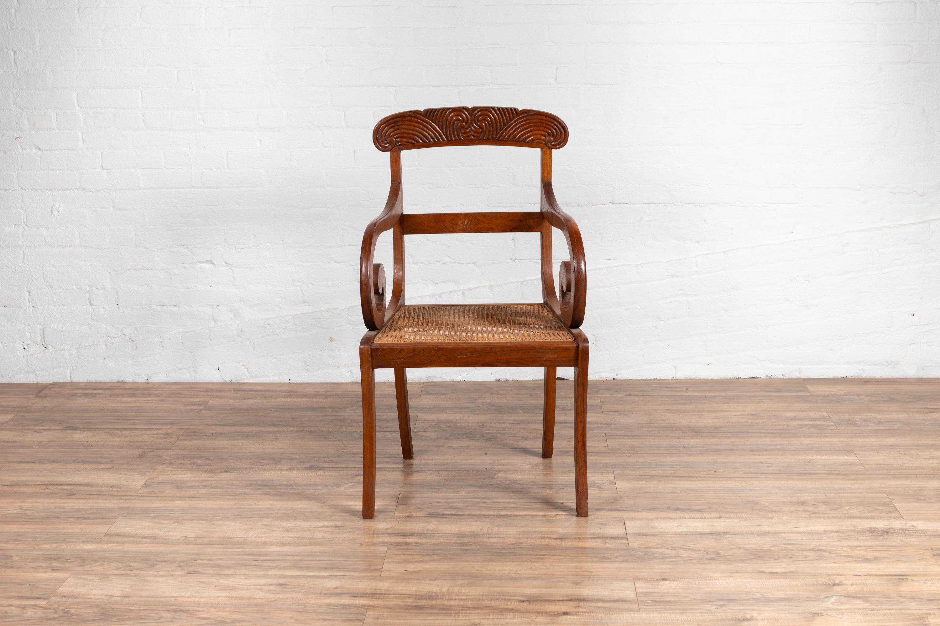 20th Century Javanese Antique Armchair with Carved Rail, Woven Rattan Seat and Curving Arms