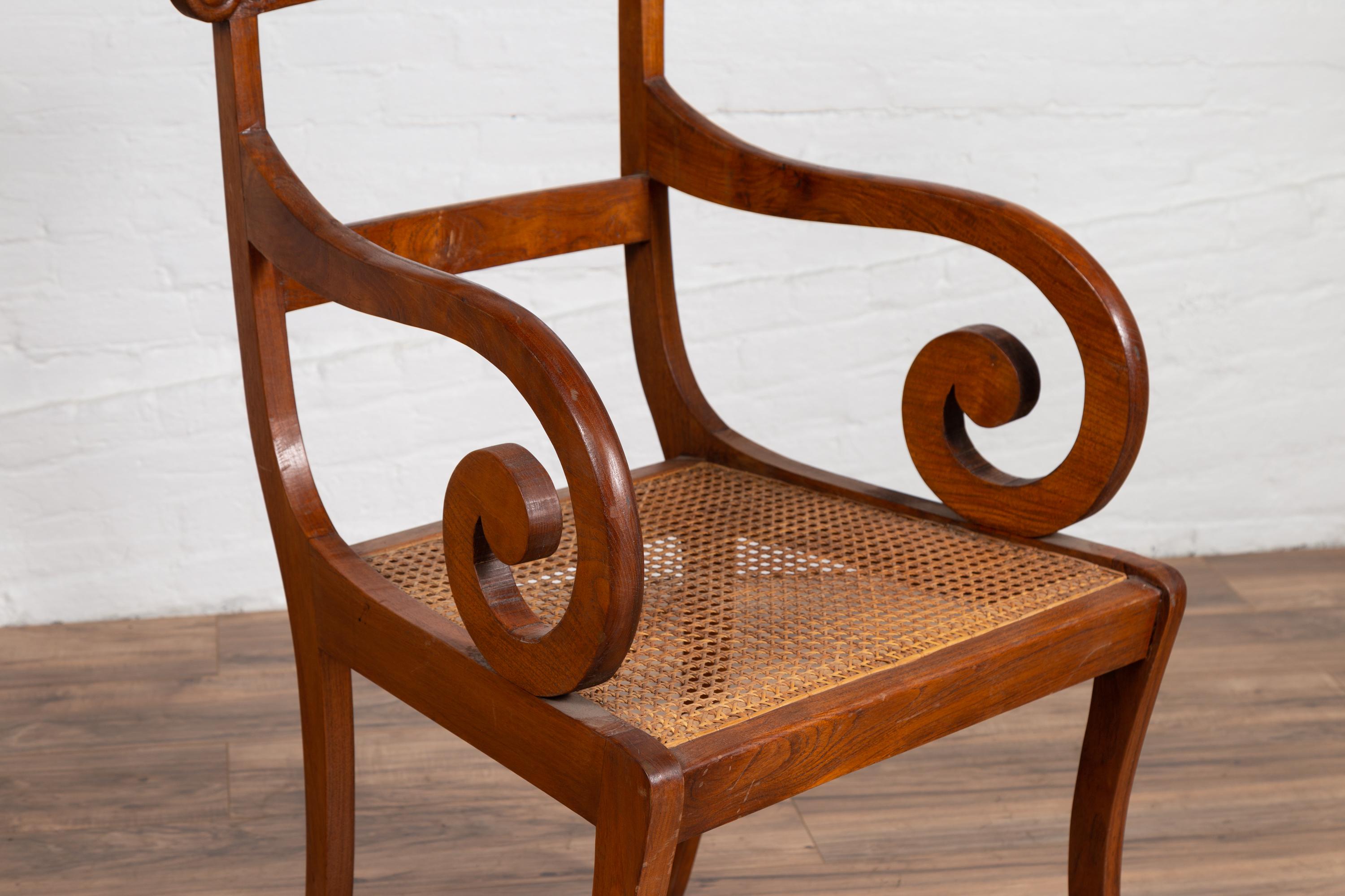 Wood Javanese Antique Armchair with Carved Rail, Woven Rattan Seat and Curving Arms