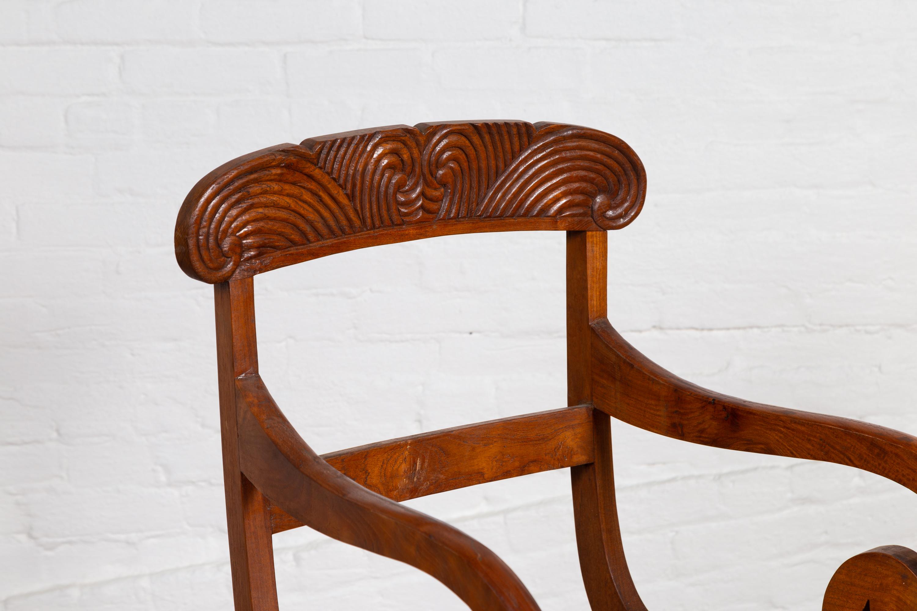Javanese Antique Armchair with Carved Rail, Woven Rattan Seat and Curving Arms 1