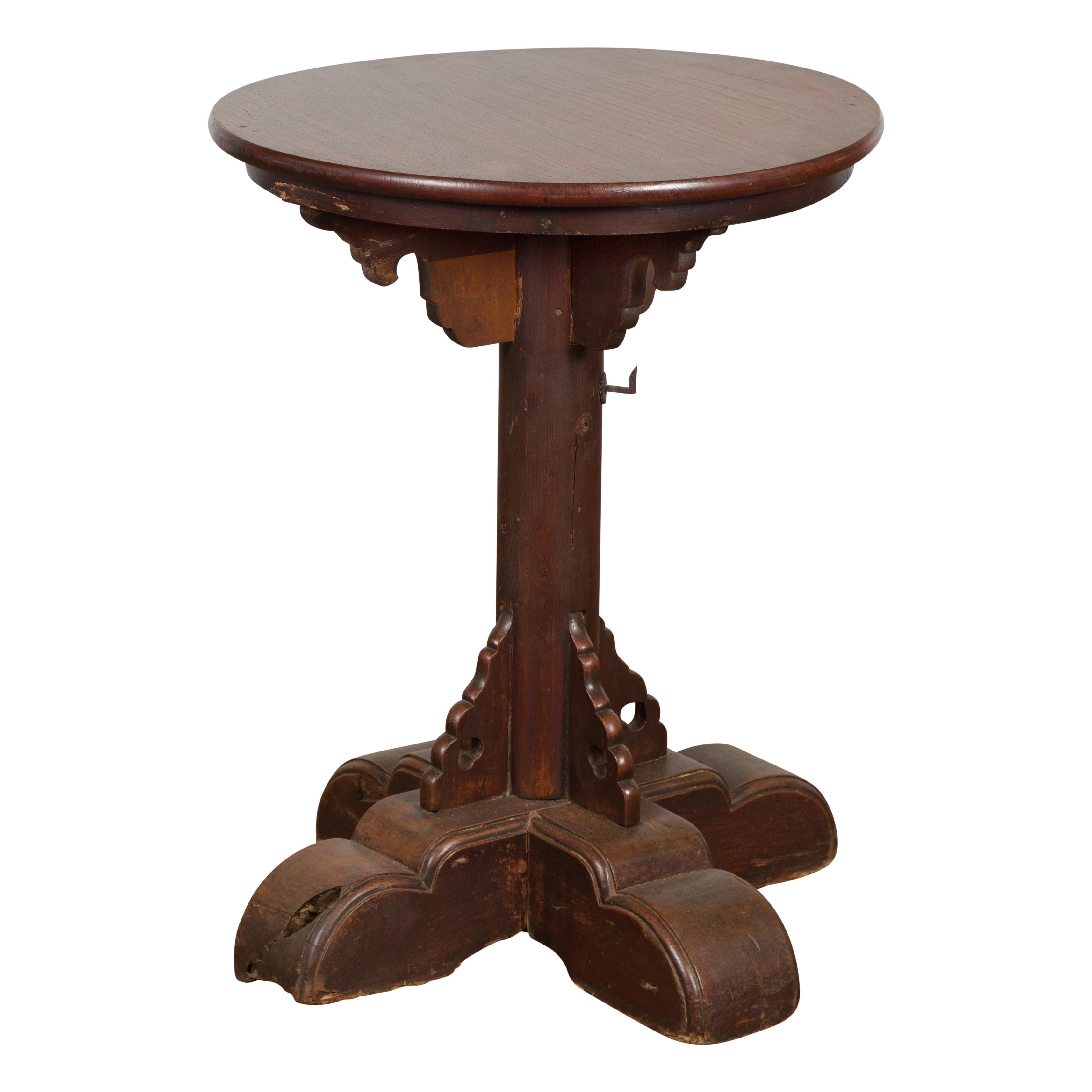 A Javanese antique pedestal table from the 19th century with circular top and quadripod base. Enhance your space with this Javanese antique pedestal table from the 19th century. Hand crafted, this table showcases a perfect balance of simplicity and