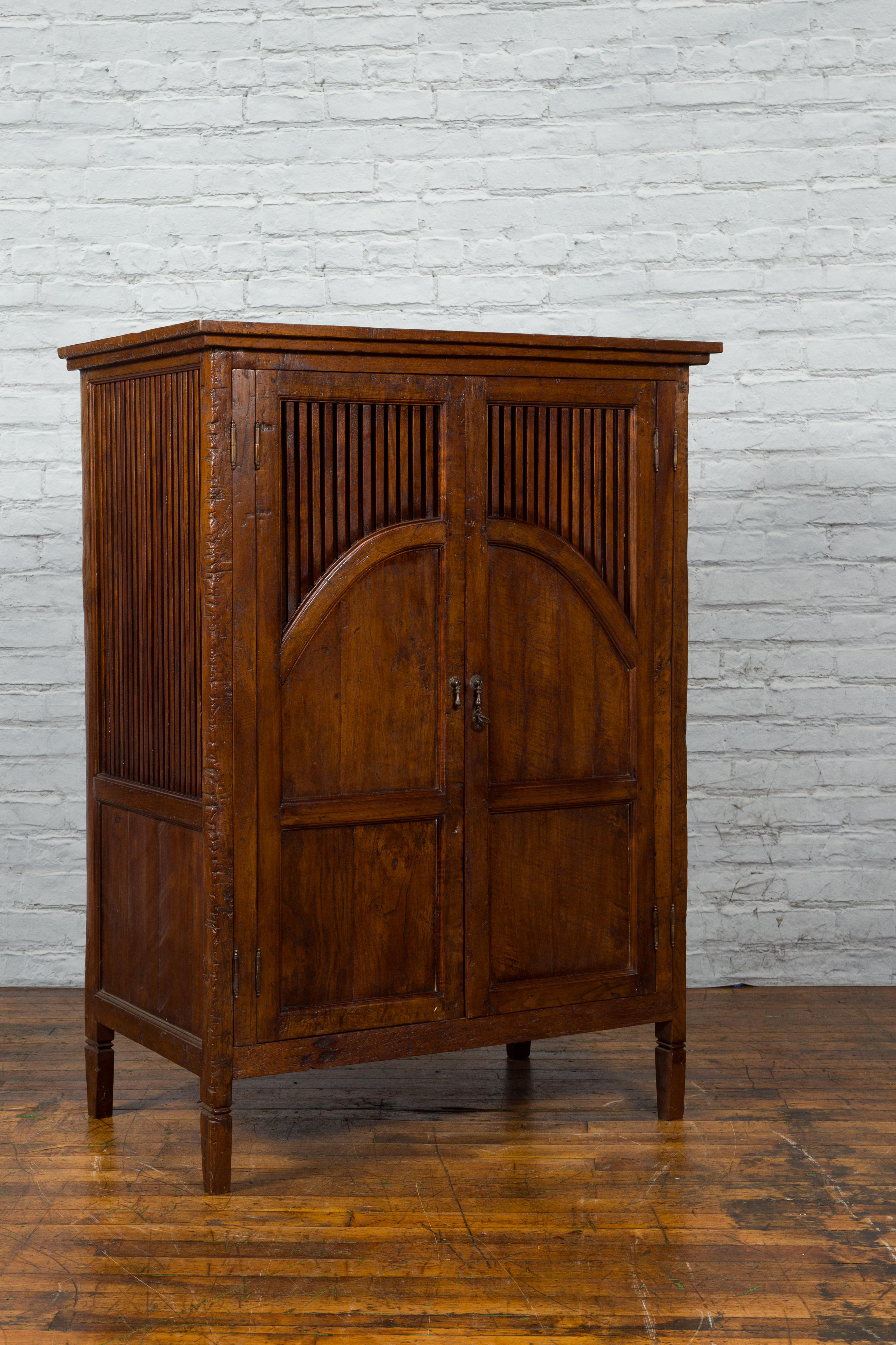 Javanese Antique Teak Armoire with Slatted Motifs, Tapered Feet and Patina For Sale 3