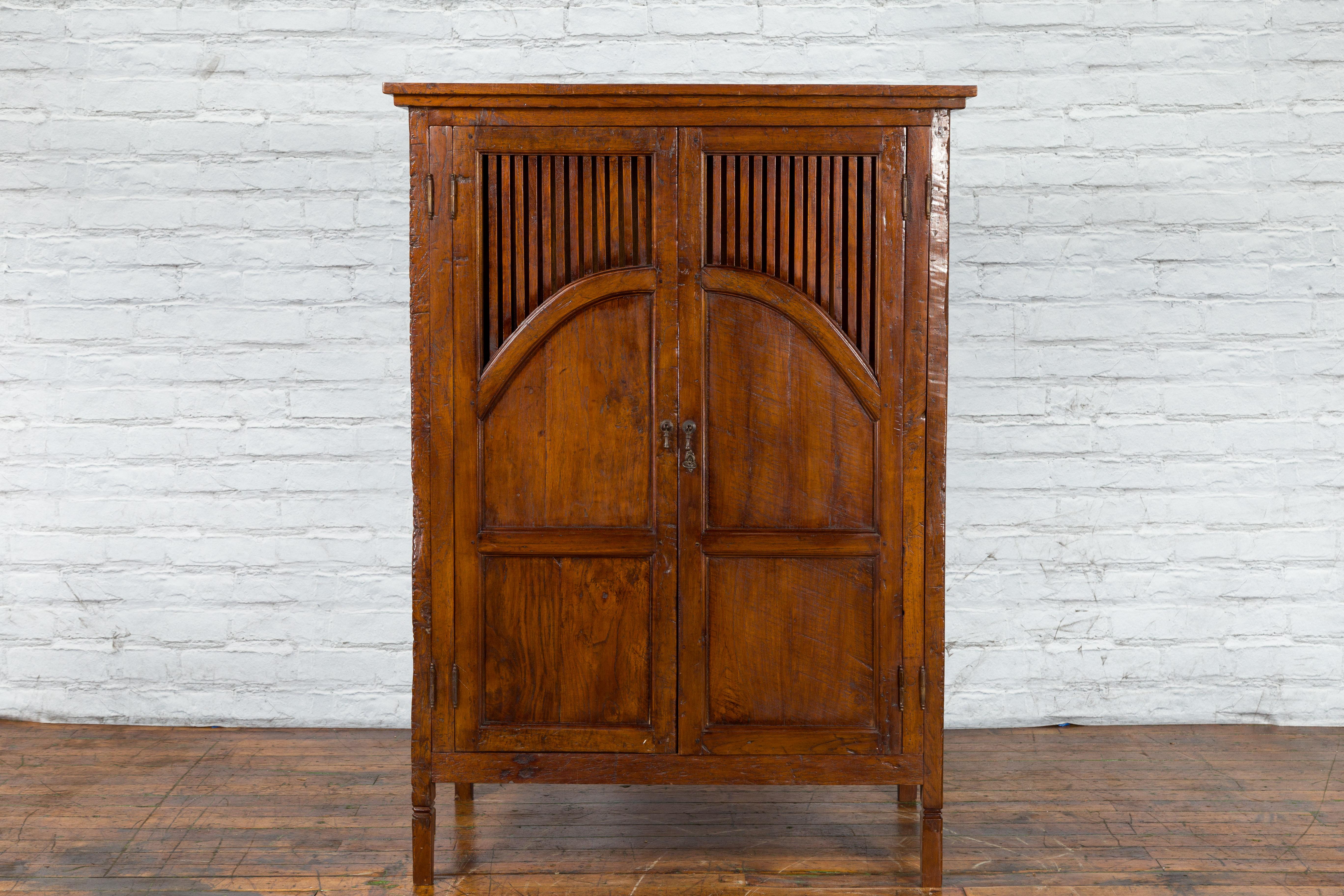 Javanese Antique Teak Armoire with Slatted Motifs, Tapered Feet and Patina For Sale 8