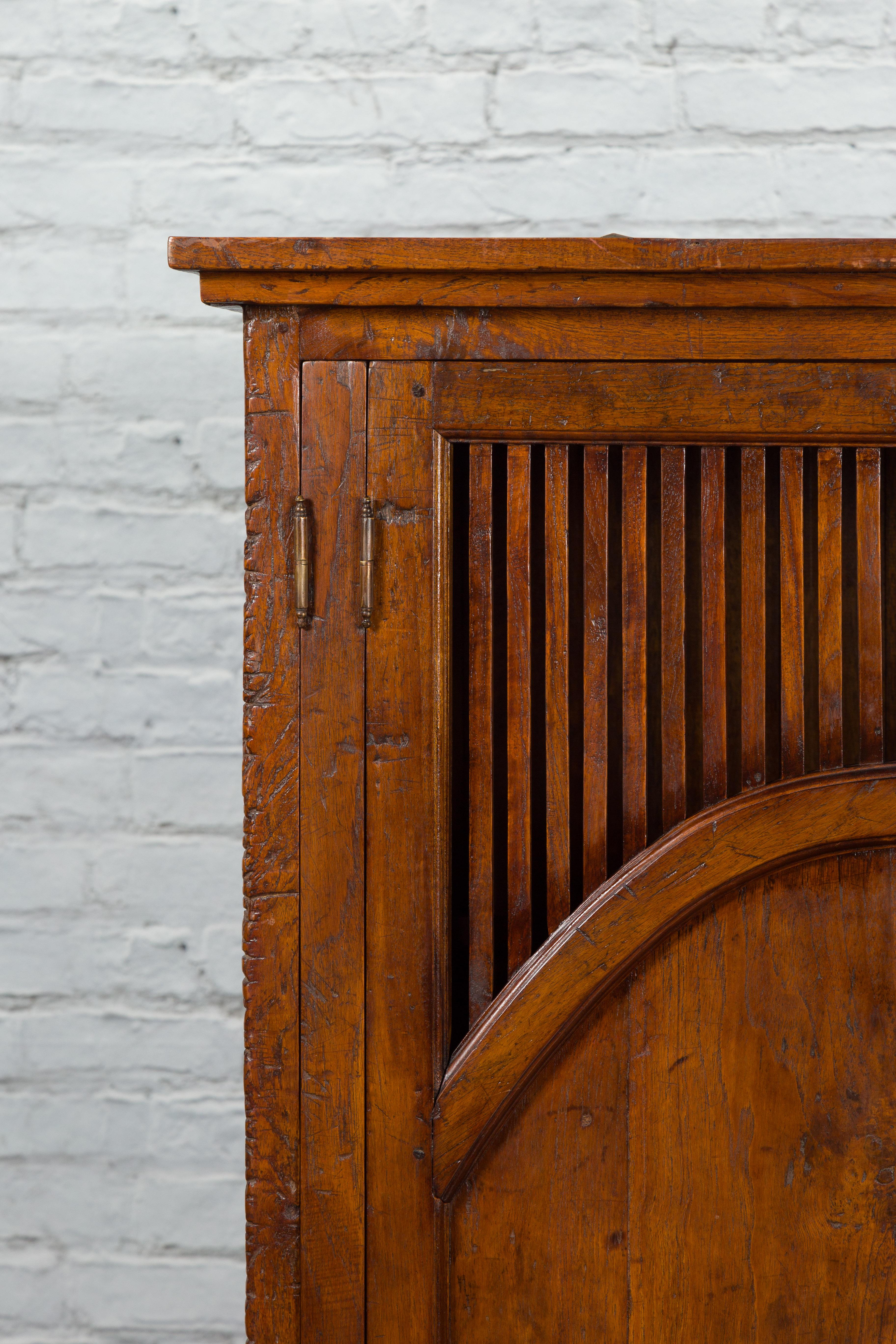 Javanese Antique Teak Armoire with Slatted Motifs, Tapered Feet and Patina In Good Condition For Sale In Yonkers, NY