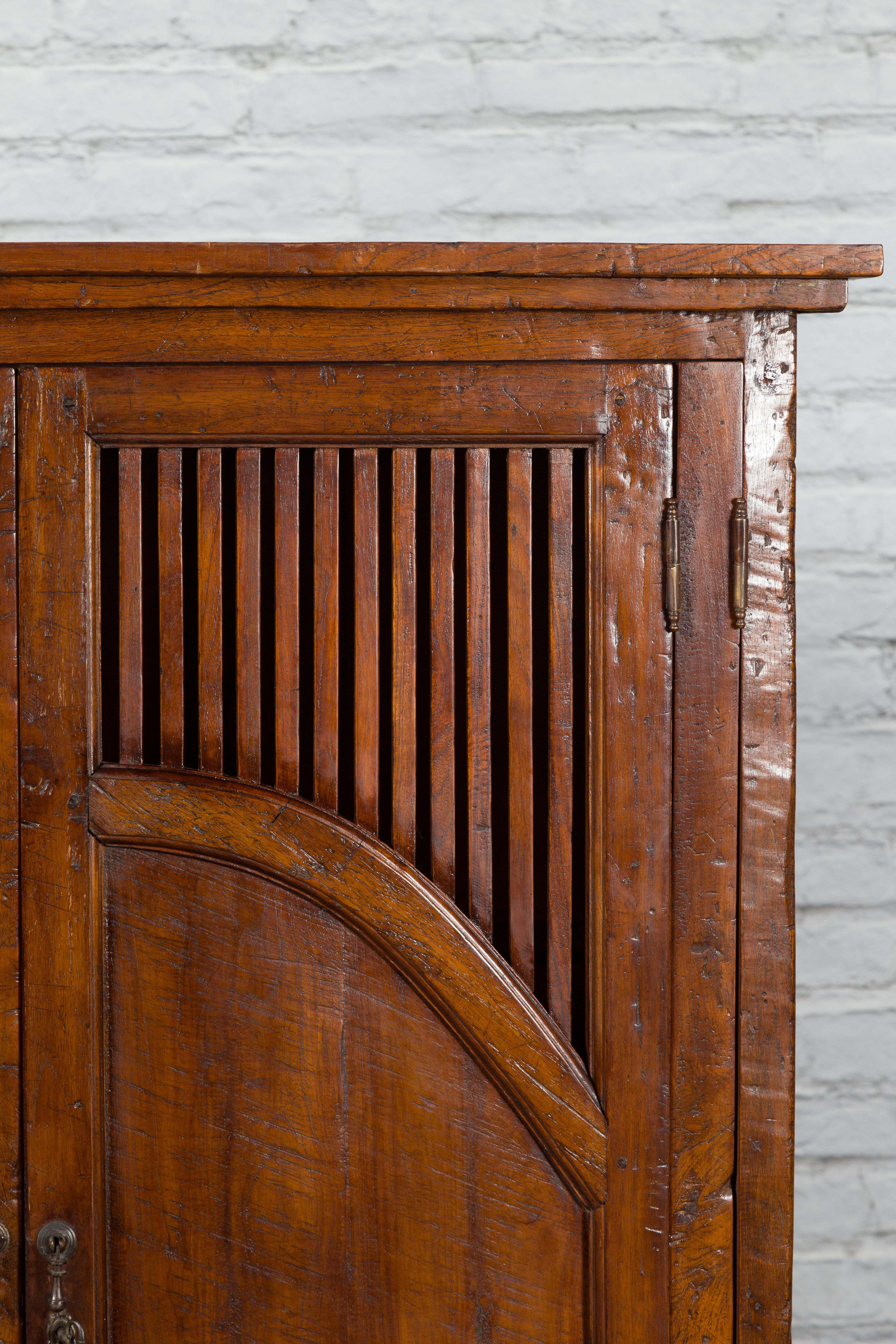 20th Century Javanese Antique Teak Armoire with Slatted Motifs, Tapered Feet and Patina For Sale