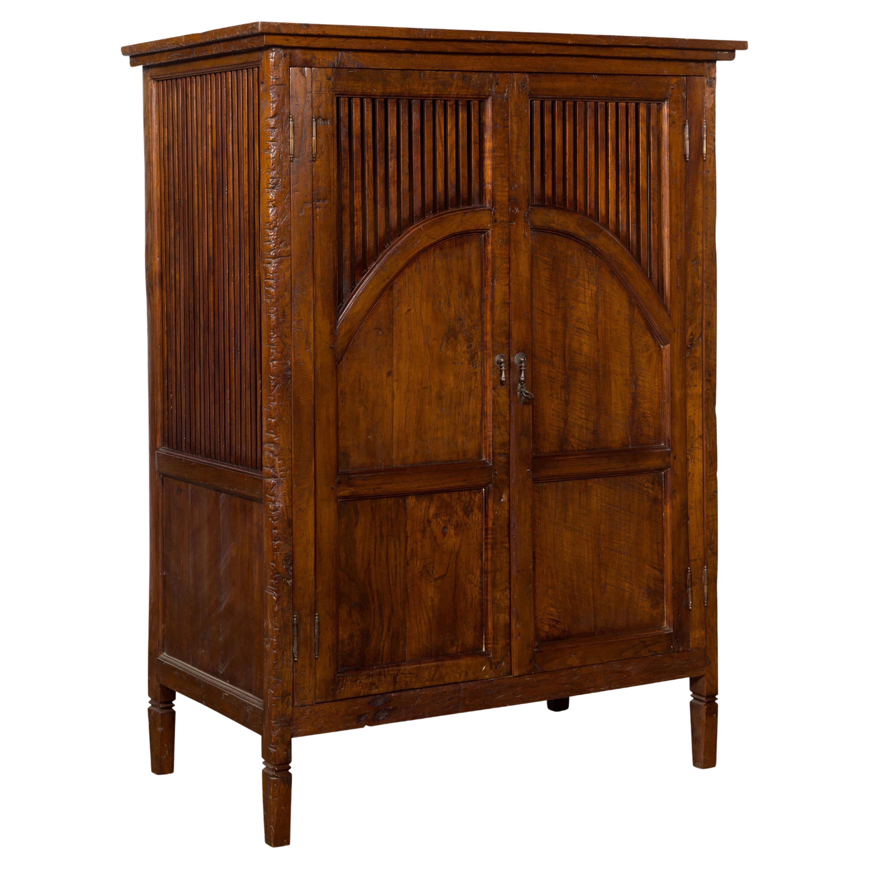Javanese Antique Teak Armoire with Slatted Motifs, Tapered Feet and Patina For Sale