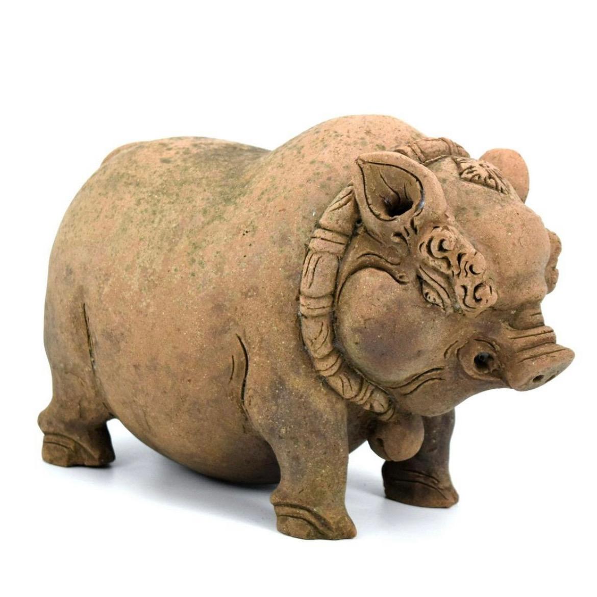 The first money-depositing object in the shape of a pig emerged in Java, Indonesia in the 14th century with the introduction of coins from China. Javanese Boars (Celeng)in the Majapahit kingdom symbolized good fortune and abundance. The hand built
