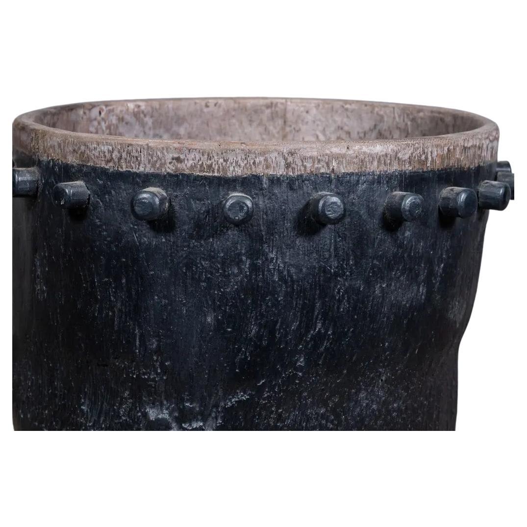 This size M Javanese drum pot, hand-carved from solid black teak, is a rare ethnic piece once used as a traditional musical instrument. Its dark patina and original wooden protrusions—once used to tighten the drum skin—now serve as refined