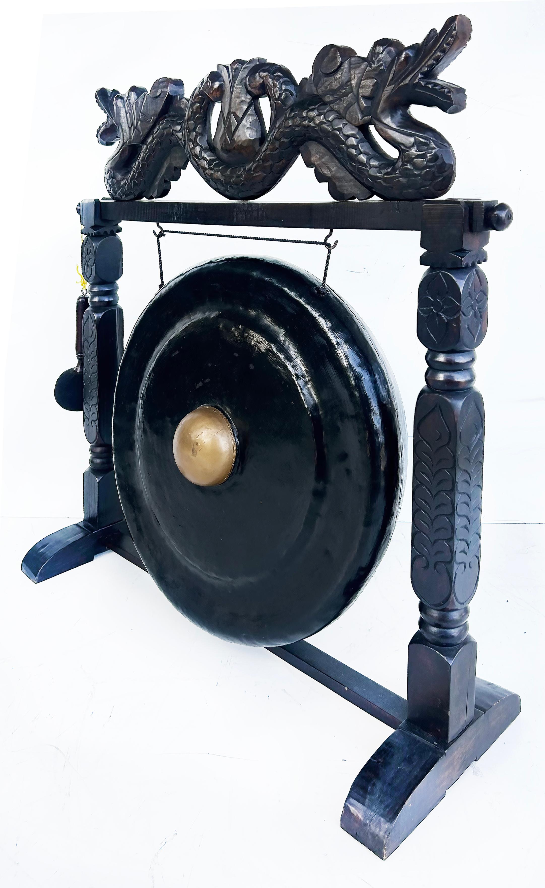 Javanese Gong on Carved Stand For Yoga and Meditation

Offered for sale is a late 20th-century Javanese wood stand with a gong suspended beneath carved dragons. Included is a softened mallet to create a wonderful long-toned gong sound. The stand and