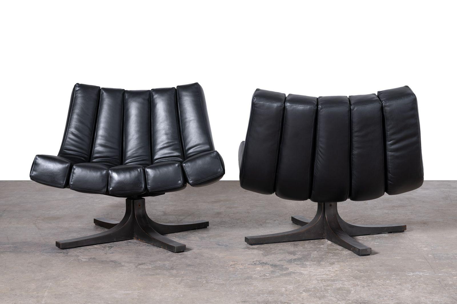 This is an extraordinarily rare pair of vintage Granada swivel lounge chairs designed by Javier Carvajal and produced by Martinez Medina in Valencia, Spain in the early 1960s. They are very substantial and the oil-rubbed brushed bronze swiveling