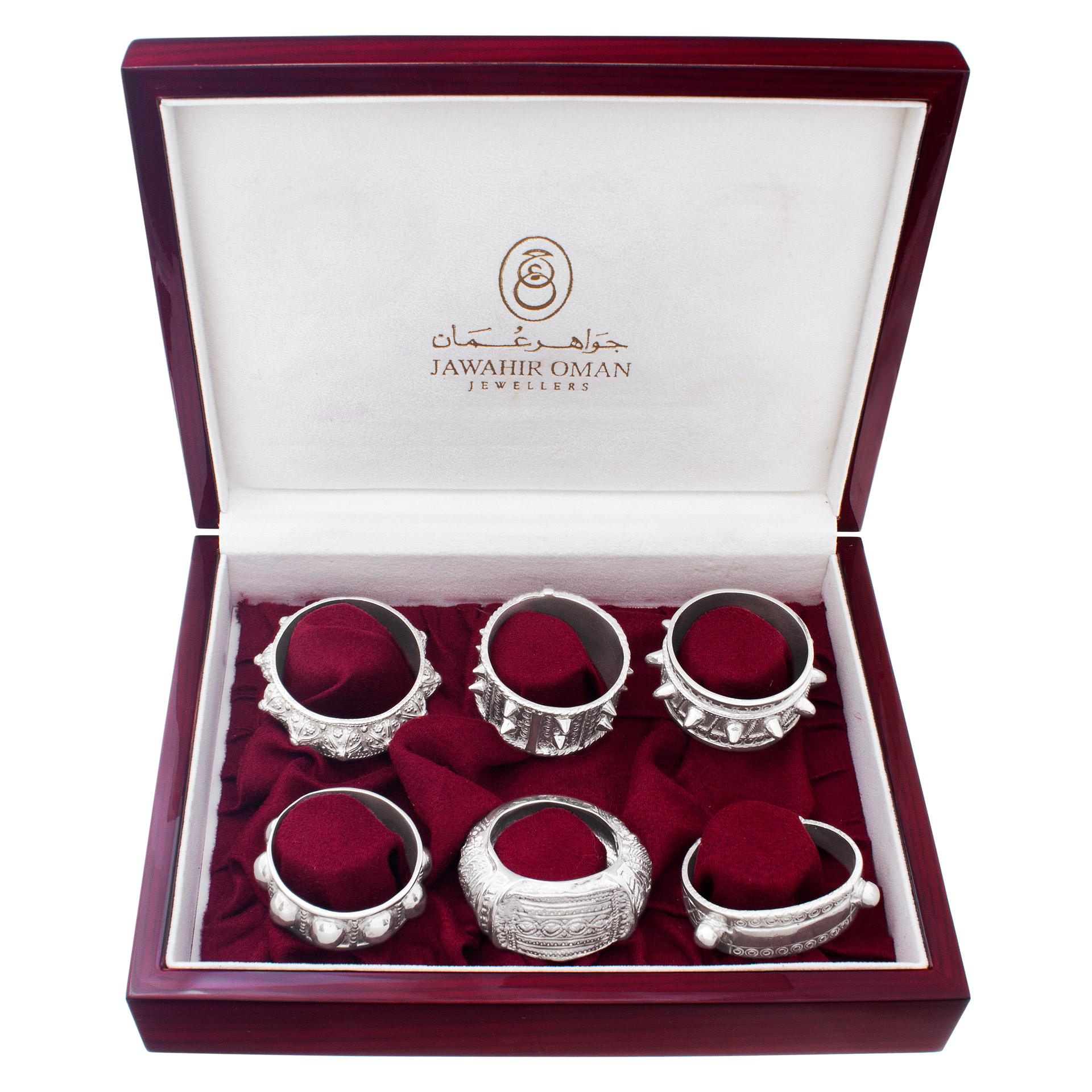 JAWAHIR OMAN JEWELERS, set of six sterling silver napkin ring each of a different design. Each napkin ring is styled like the original Oman bangle bracelet. Complete in original wooden presentation box. Heritage collection is inspired by the
