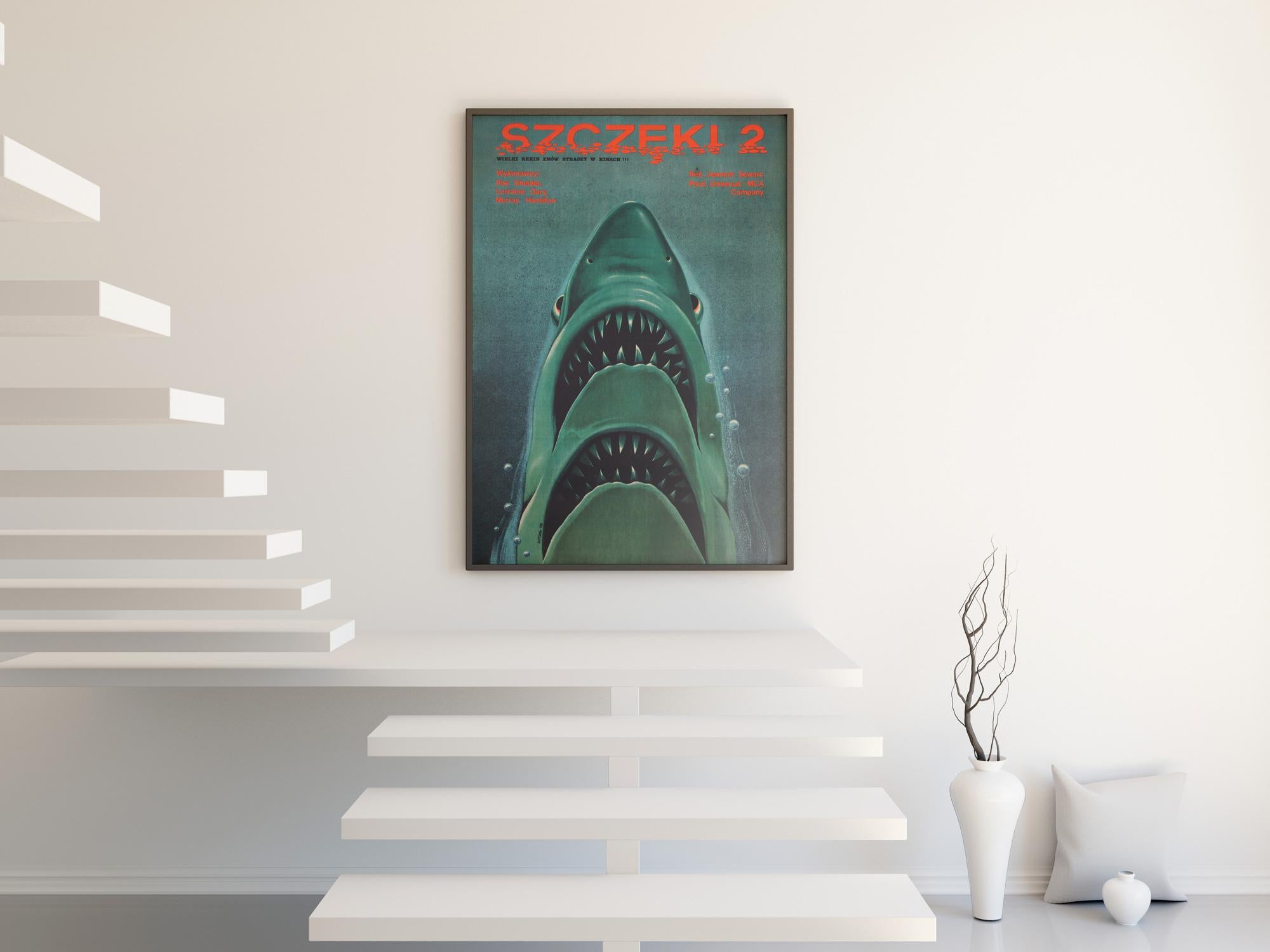 The poster with plenty of bite. Double in fact!

We adore Edward Lutczyn's wonderful double-jawed shark design on the Polish film poster for the Jaws sequel. A very inventive derivative from Kastel's original design for the first film.

The end