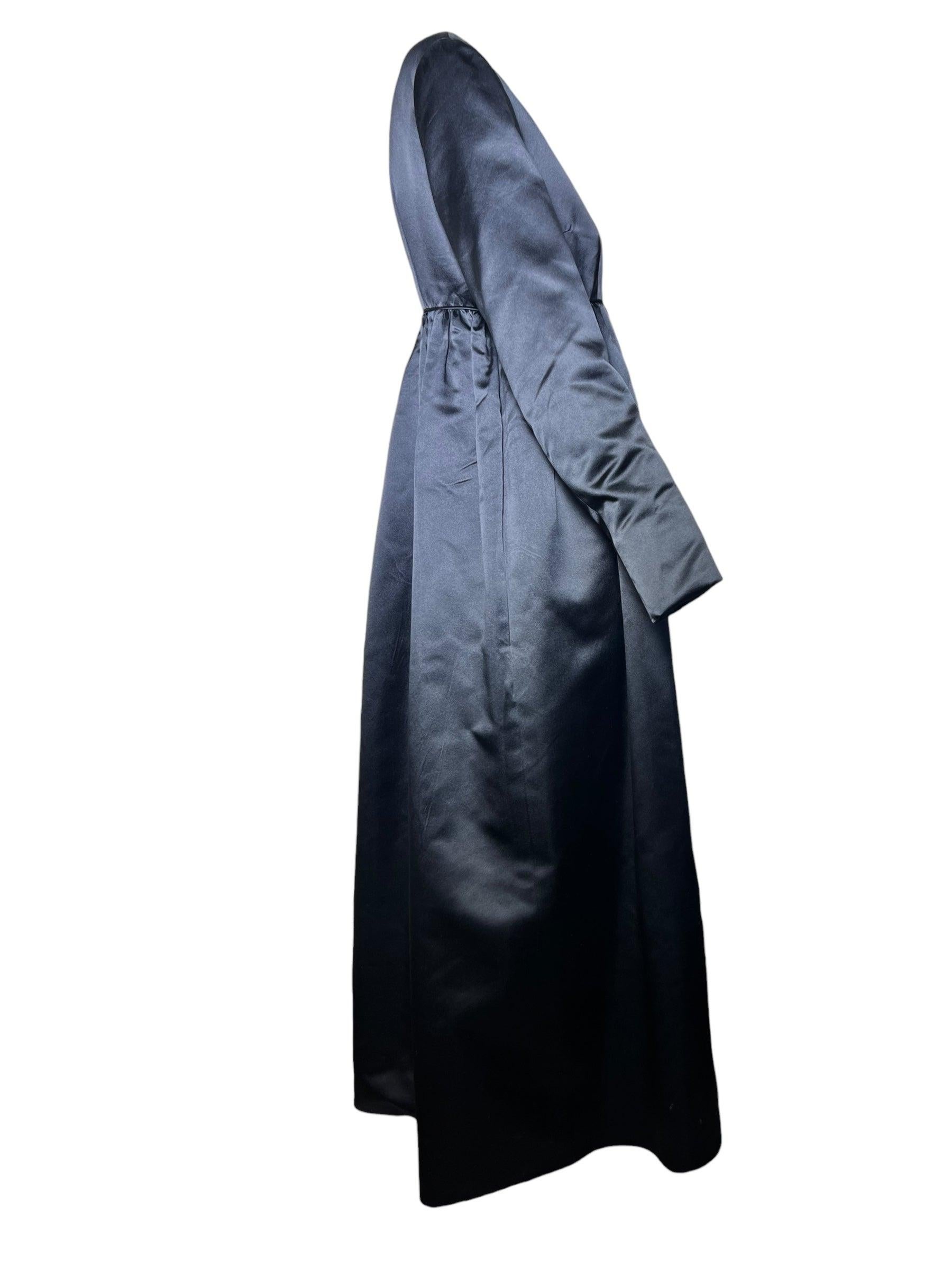 Elegant black satin baby doll silhouette evening coat by cult favorite Jax. Jack Hanson of Jax first made a splash in the late '50s and early '60s styling Hollywood starlets such as Marilyn Monroe and Audrey Hepburn in curve-hugging tapered