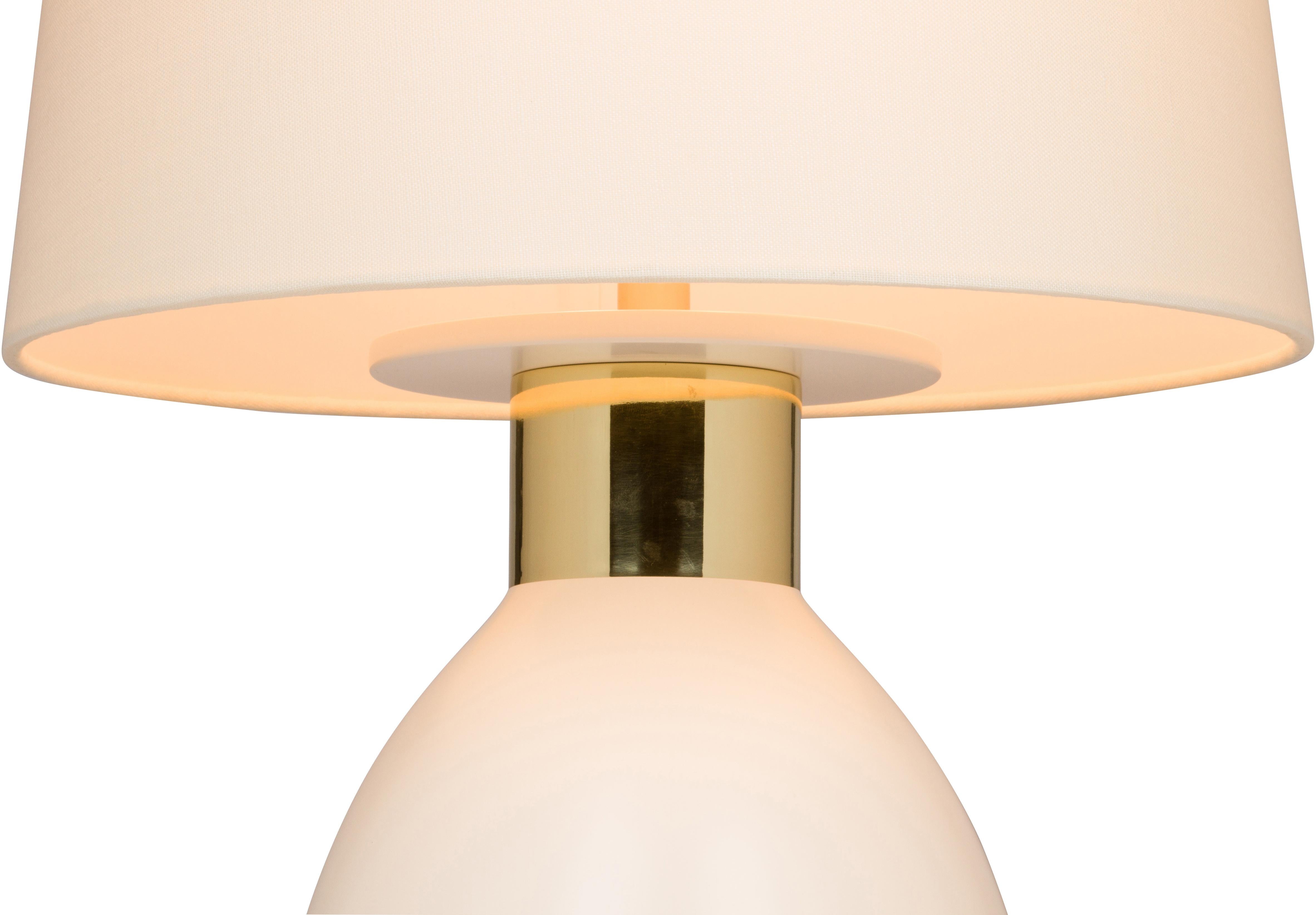 The voluptuous Jax table lamp from Marian Jamieson is hand turned on a lathe out of solid wood. It is then lacquered in any color
Specified and finished off with a spun brass collar -available in a number of finishes- that accentuates the base and