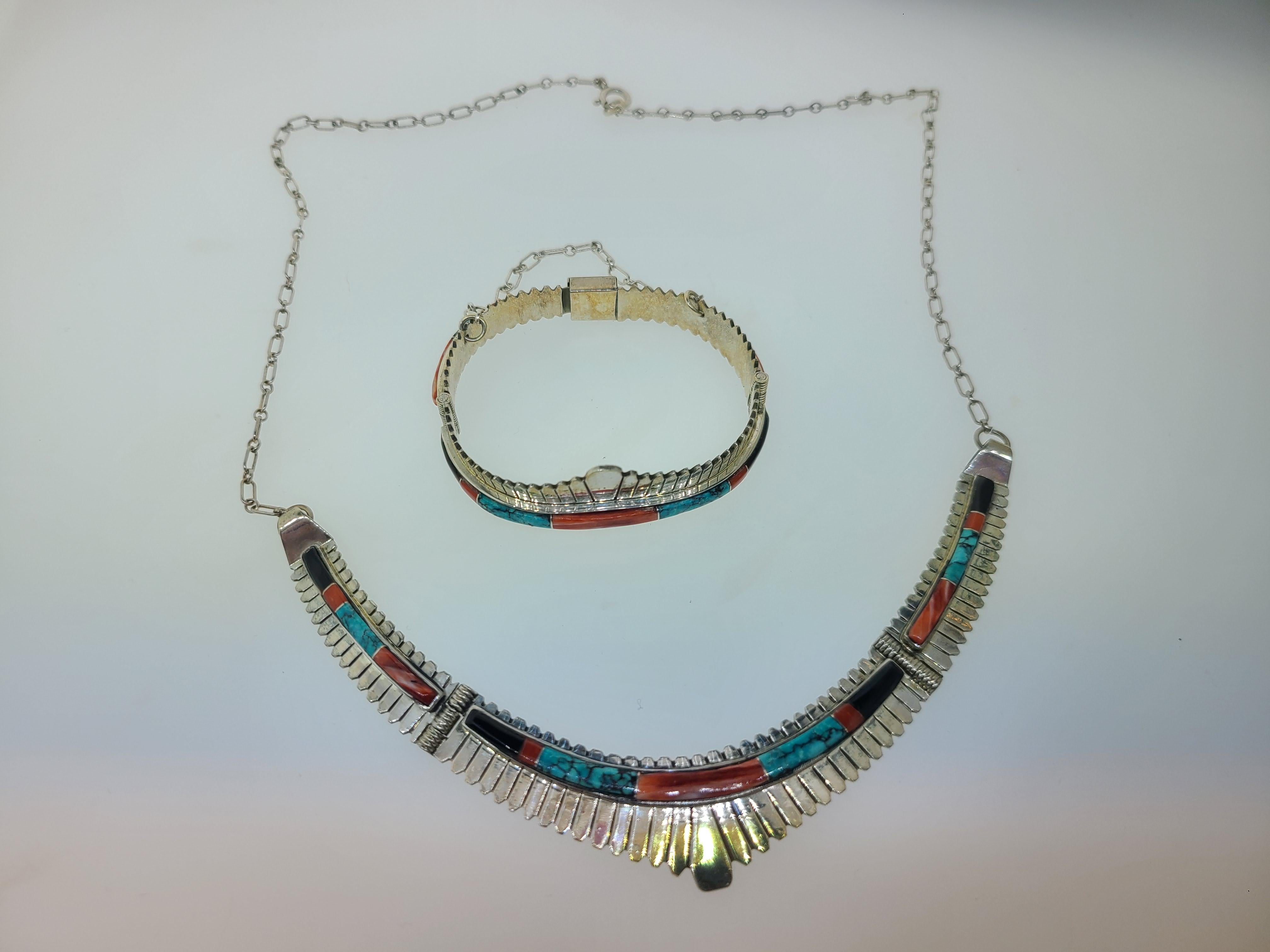 This estate found classic Southwest Native American Indian design necklace and bracelet set
made by Jay Boyd is sterling silver and inlaid with genuine Turquoise, Coral, and Jet Black.
Signed Jay Boyd Sterling on the back of the necklace and