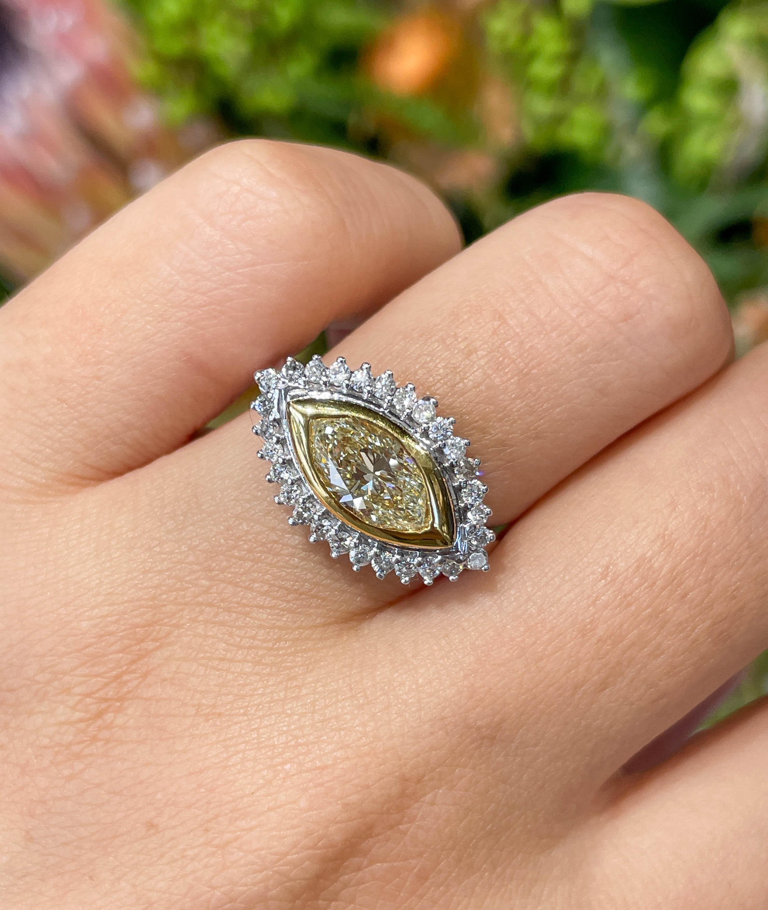 Jay Feder Diamond ring in 14k Two-tone gold with 1.27ct Yellow Marquise diamond in the center, set East-West way into a diamond halo; estimated total weight of white diamonds is 0.56ctw; G-H color and VS clarity overall.

The top’s measurements are