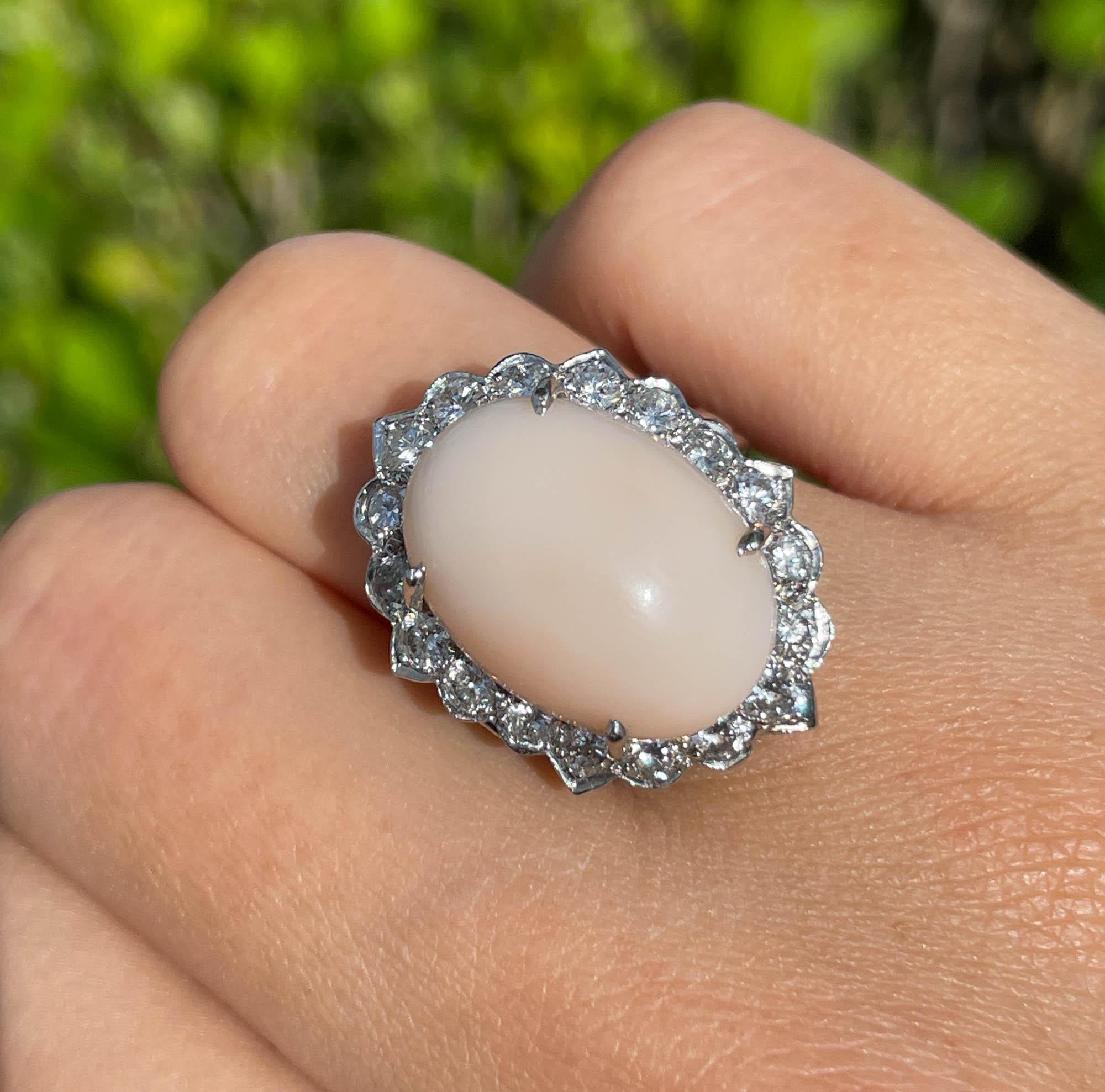 Jay Feder 14k White Gold Cabochon Pink Coral Diamond Halo Ring
Estimated total weight of diamonds is 1.62 tcw.
The top’s measurements are 24.51x17.71mm. The band tapers from 3.00mm to 5.23mm on the bottom; sits 13.86mm from the top of the finger.