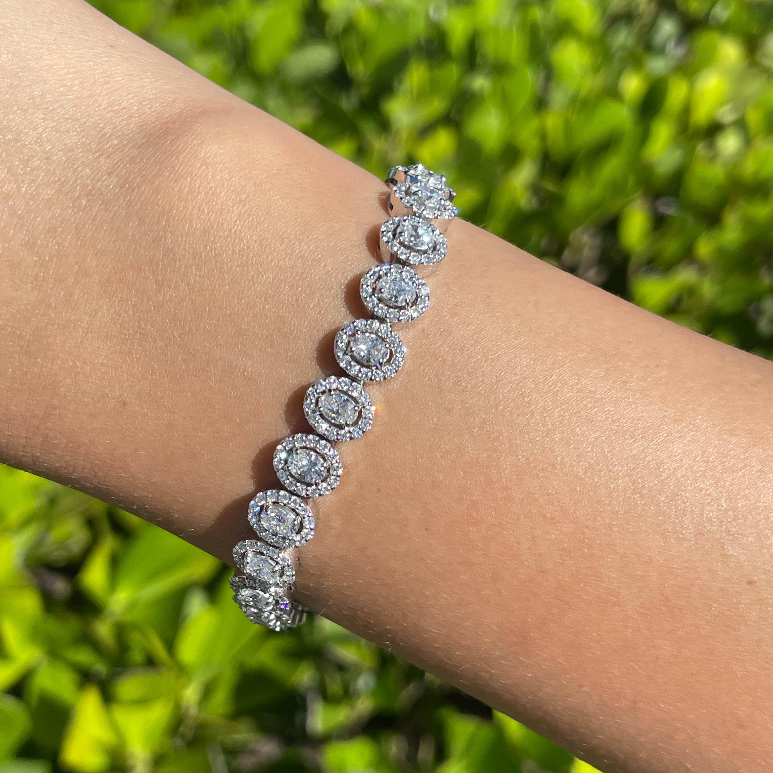 Jay Feder 14k White Gold Diamond Oval Halo Tennis Bracelet

Set with 24 ovals and 336 round brilliant diamonds; total carat weight is 7.25ctw. 

The bracelet is 7 inches long and 8.21mm wide. Total weight is 20.8 grams. 

Please view our photos and