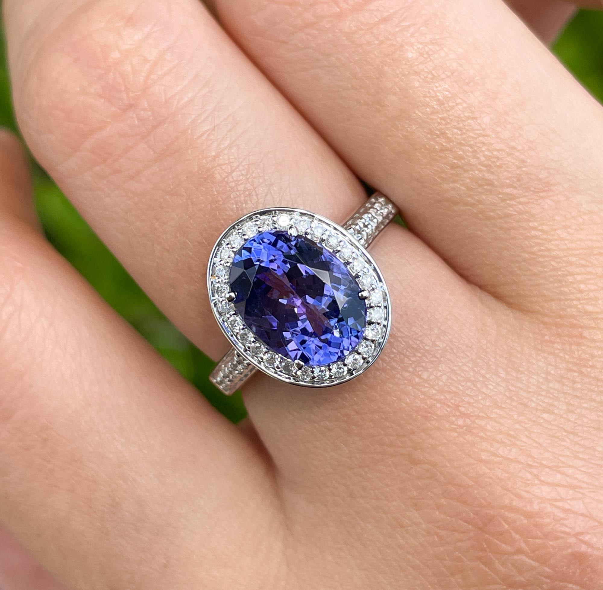 Jay Feder 14k White Gold Tanzanite and Diamond Halo Ring 

The center stone is 3.54ct Oval shaped Tanzanite. Set with 39 round diamonds in halo and on the band, total carat weight is 0.27ct.

The top's outline measurements are 14.30x11.68mm. The