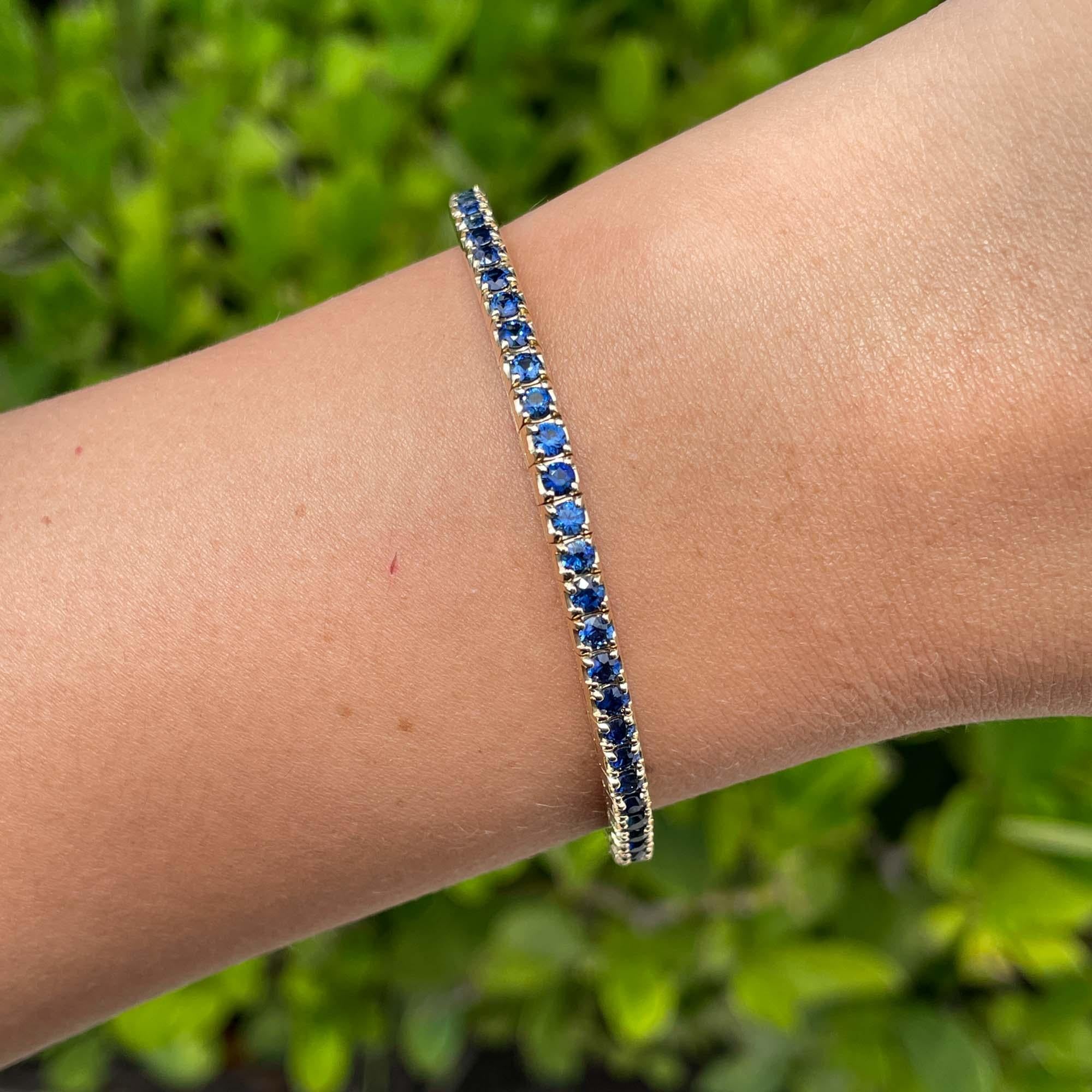Jay Feder 14k Yellow Gold Blue Sapphire Stretch Tennis Bangle Bracelet

Set with 63 round blue sapphires; total carat weight is 5.72ctw.

The bracelet is 2.5 inches in diameter and 3.50mm wide. Total weight is 14.7 grams.

Please view our photos and