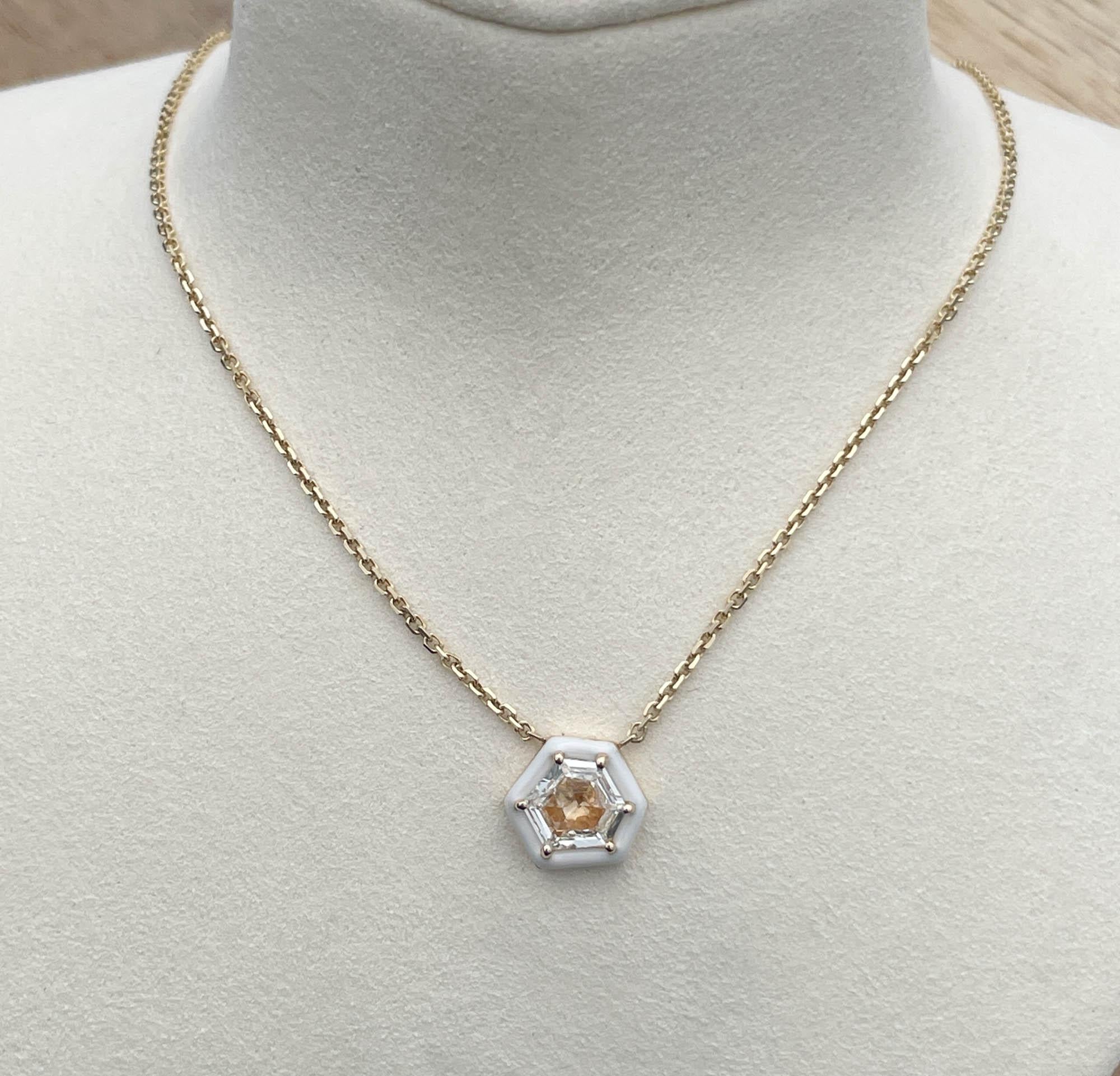 Jay Feder 14k Yellow Gold Diamond Enamel Hexagon Pendant Necklace. The misshaped hexagon diamond is approx. 1 carat.
The pendant’s measurements are 9.68x10.38mm. The necklace is 18 inches long (with bolo). The total weight of the necklace is 4.4